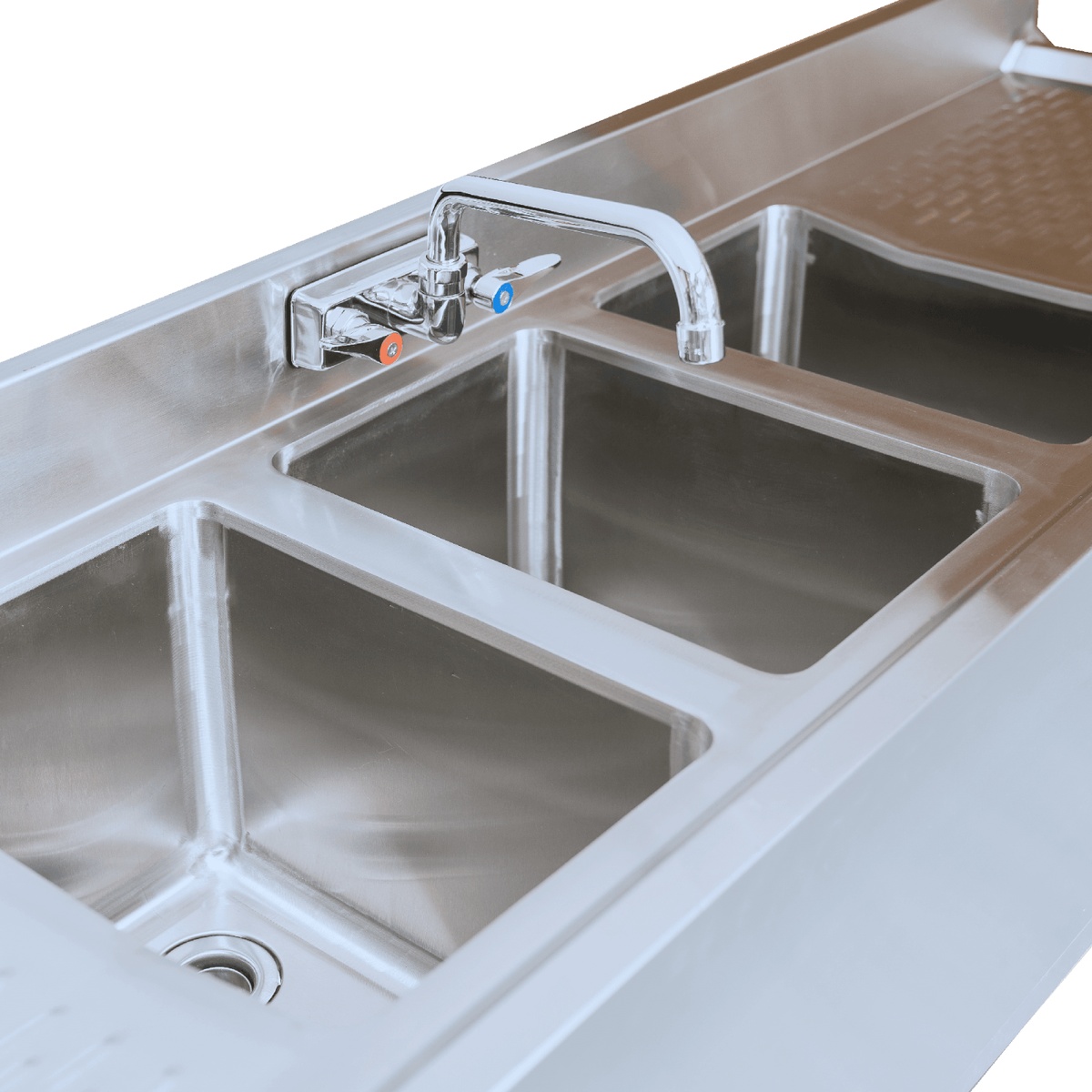 Close-up detail of the E-BAR3B72-LR three stainless steel sink tubs with faucet and textured drainboard surface