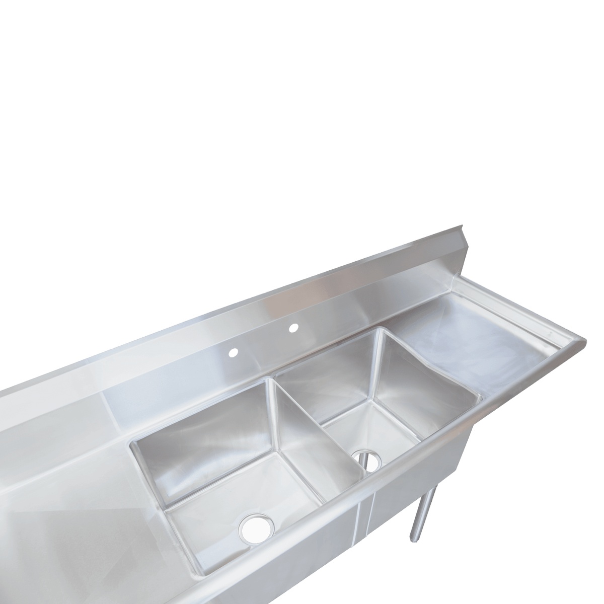 Angled overhead close-up of stainless steel two-compartment sink tubs with drain openings and right drainboard