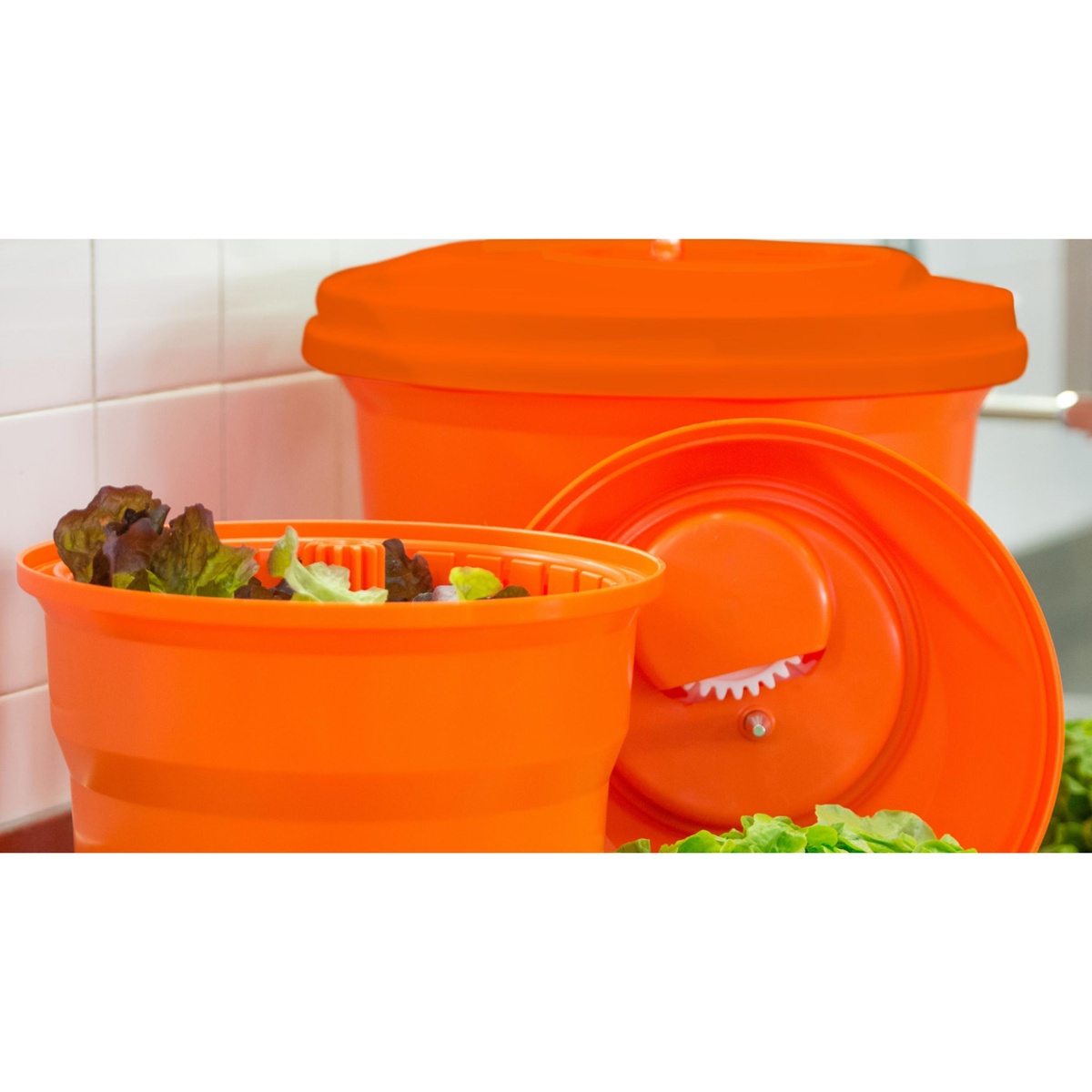 Dynamic USA salad spinner showing orange inner basket with lettuce and main unit with lid