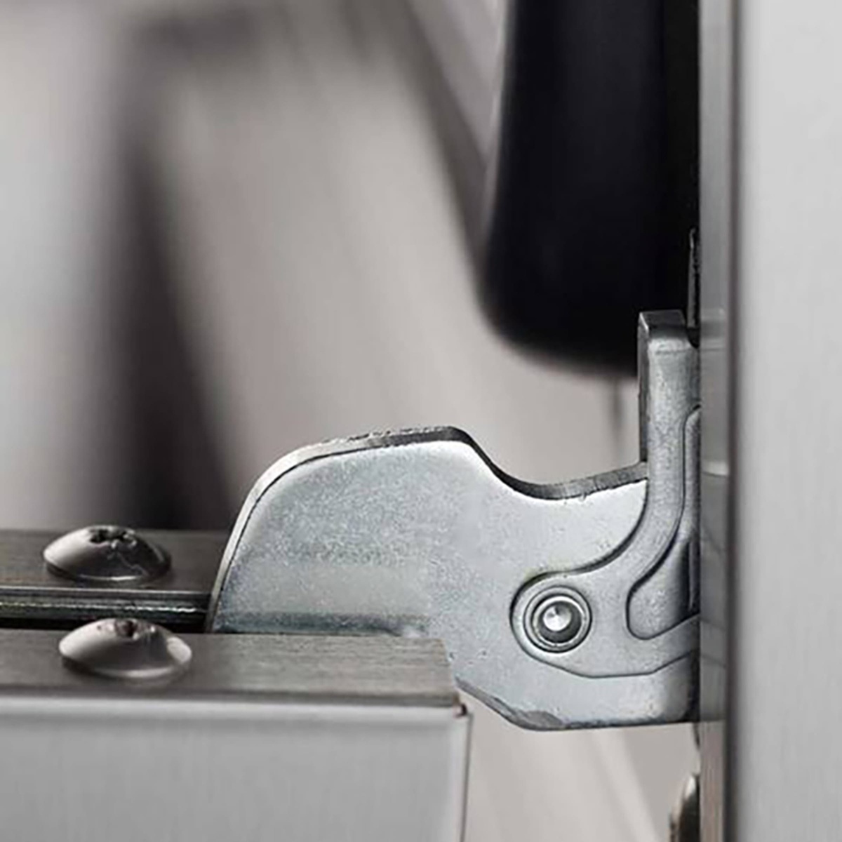 Close-up of the Turbofan E27M3 oven door hinge hardware