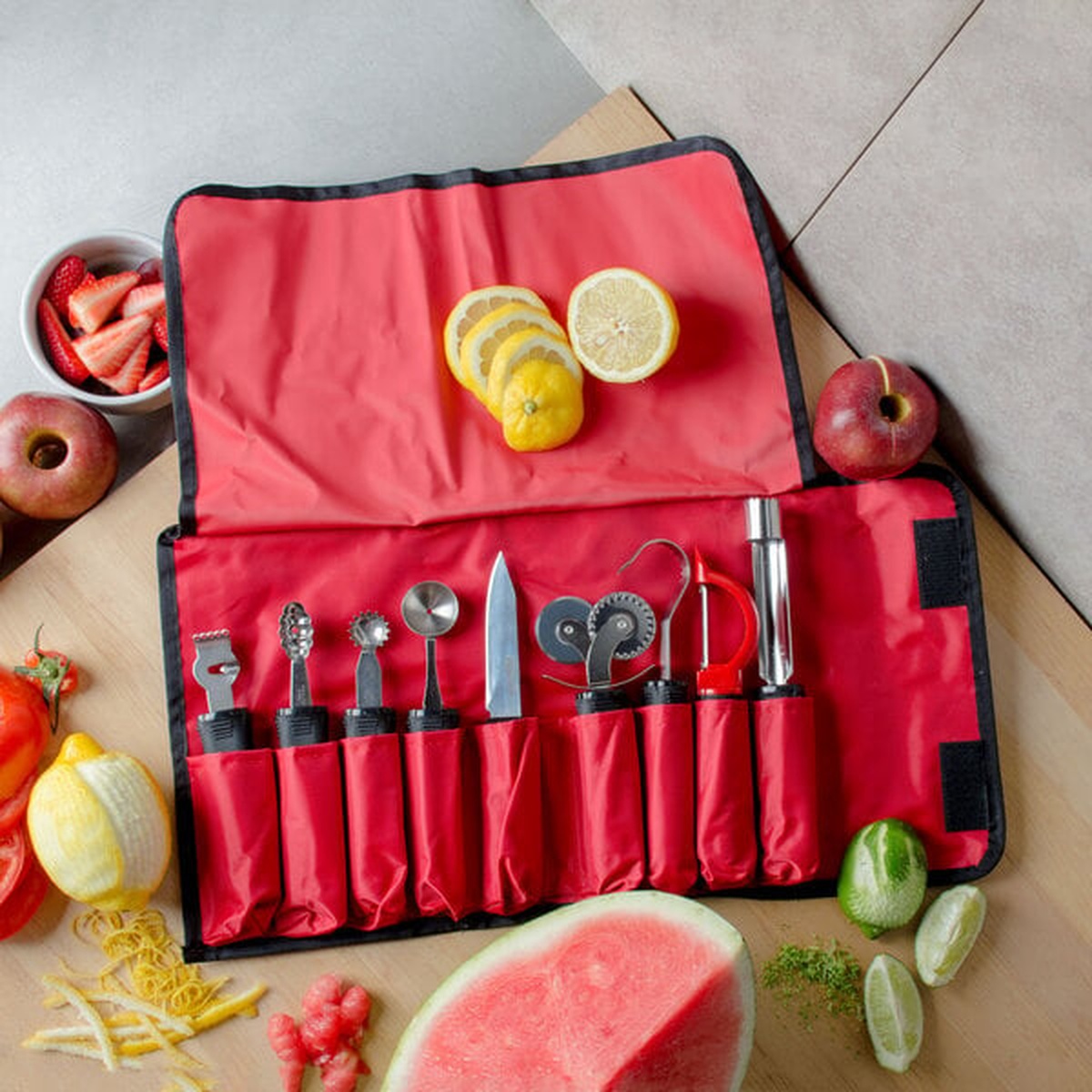 TableCraft garnishing tools displayed with sliced lemons, apples, and watermelon on a wooden surface.