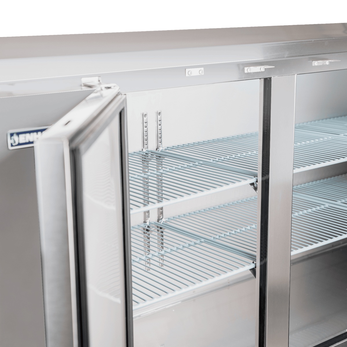 Interior close-up of Enhanced back bar cooler showing adjustable wire shelving and open solid door