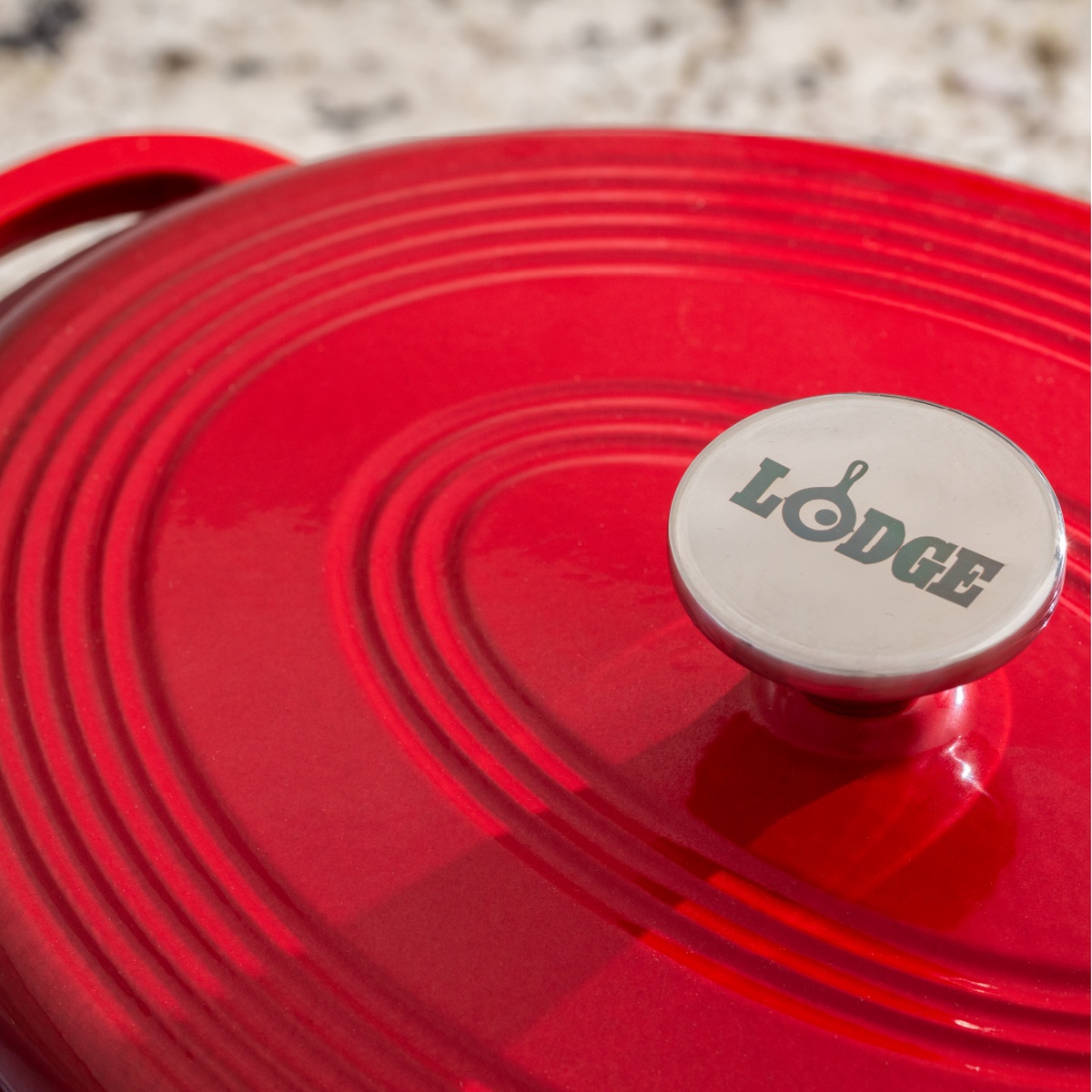 Close up of the stainless steel knob and red enameled lid