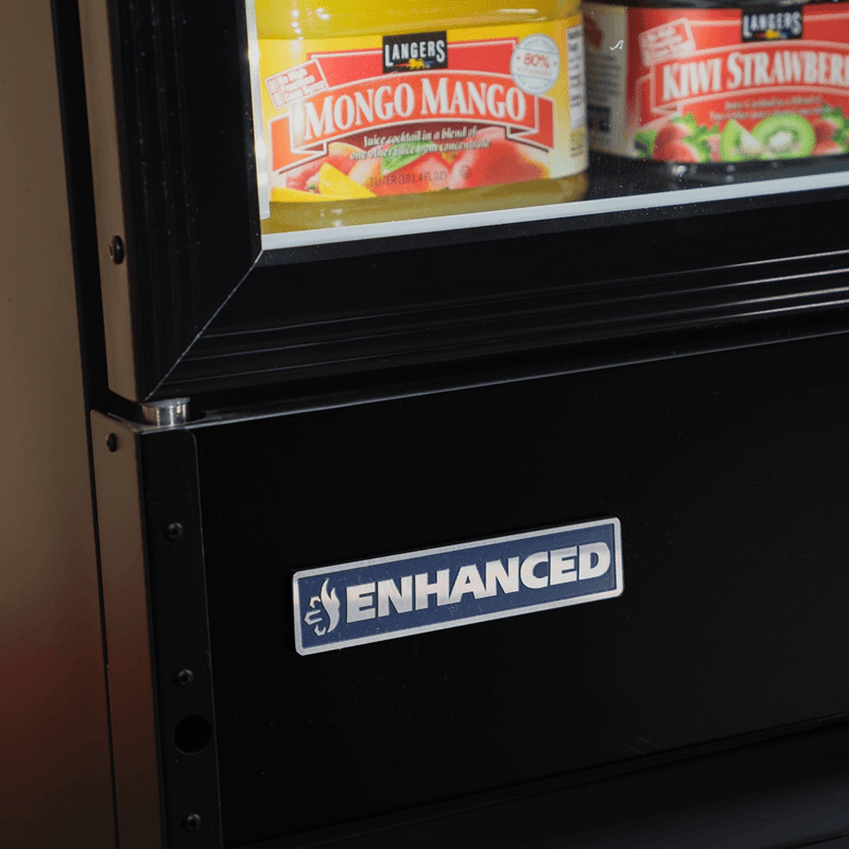 Close-up of the lower front panel with Enhanced brand badge