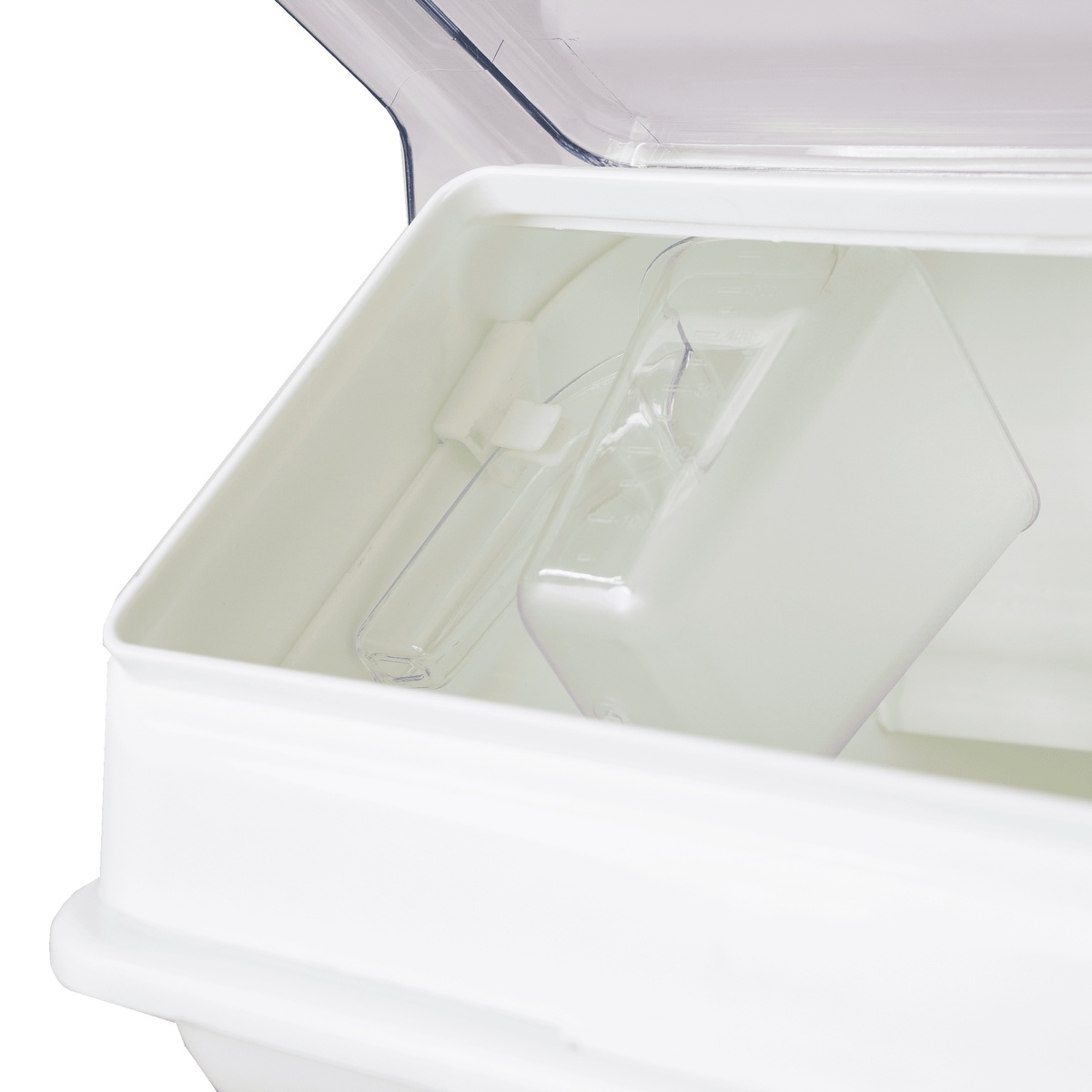 Close-up of ingredient bin interior showing clear 2.5-cup measuring scoop resting inside
