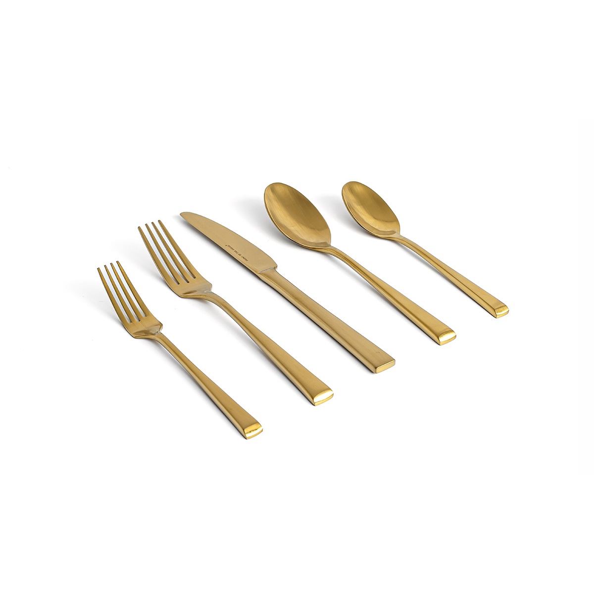 Parker matte brass flatware collection including two forks, dinner knife, and two spoons on white background