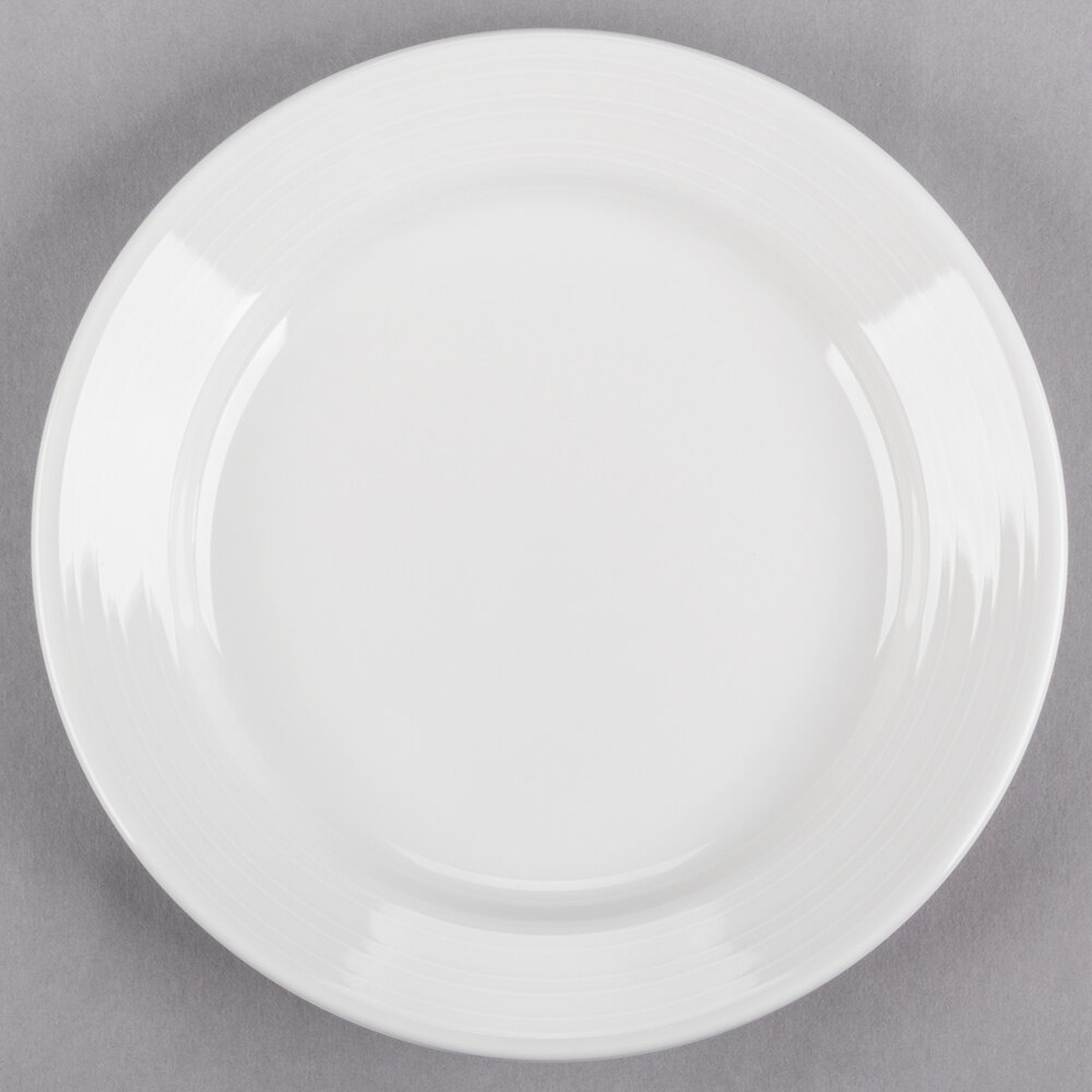 Tuxton Pacifica FPA-072 bright white embossed china plate, top-down view showing full round profile