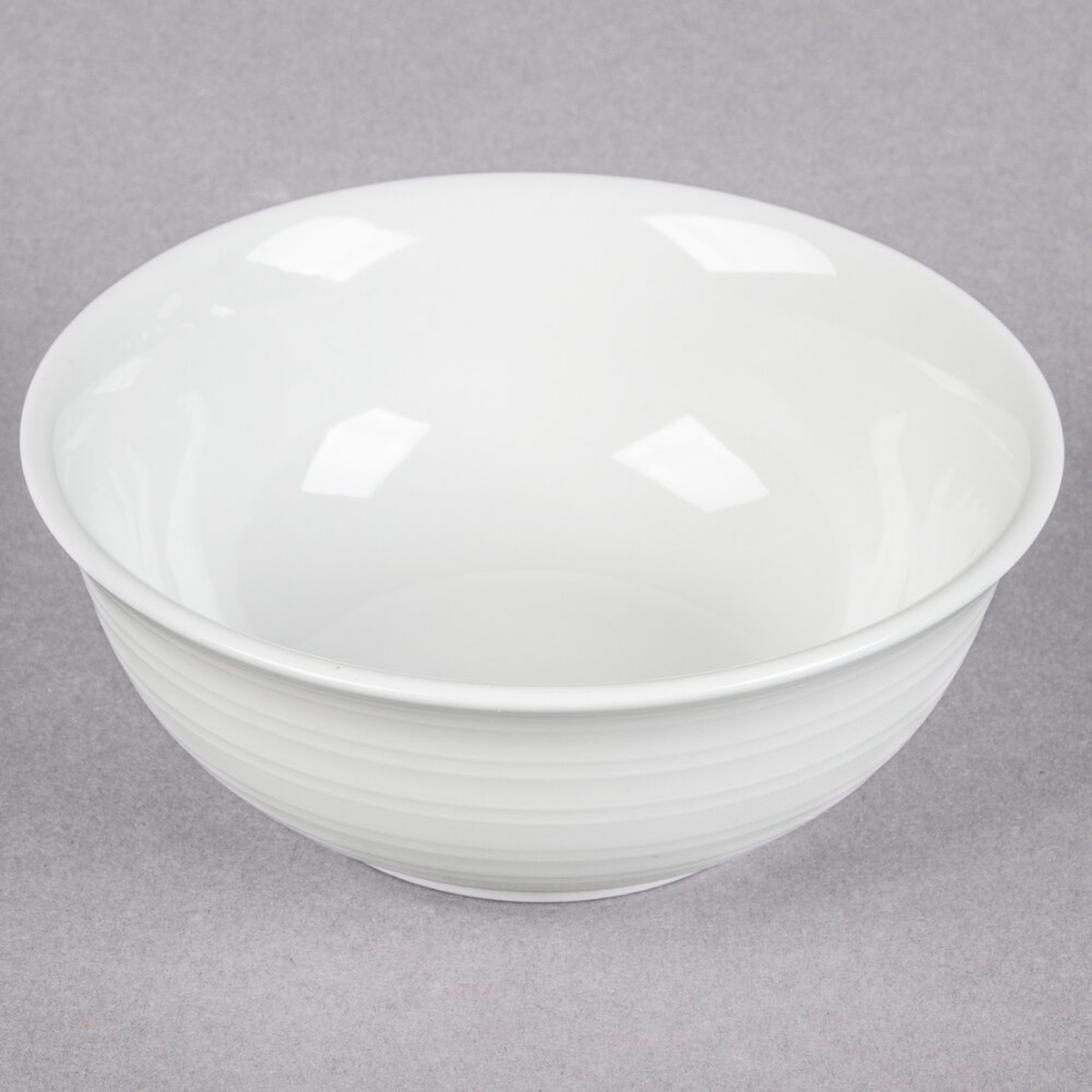 Tuxton FPB-140 Pacifica bright white embossed porcelain nappie bowl, top-angle view showing interior