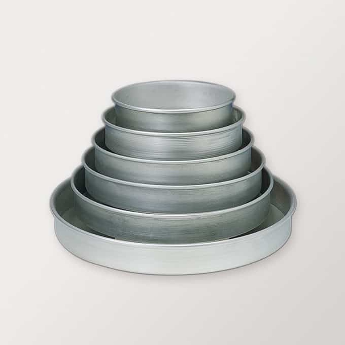 Stacked American Metalcraft hard anodized aluminum pizza pans in multiple sizes