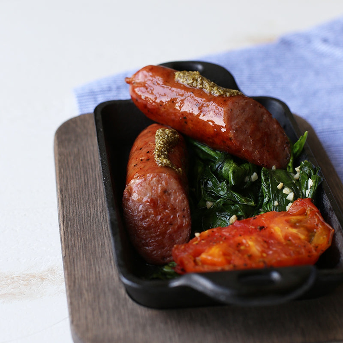 Lodge mini server with cooked sausages and vegetables