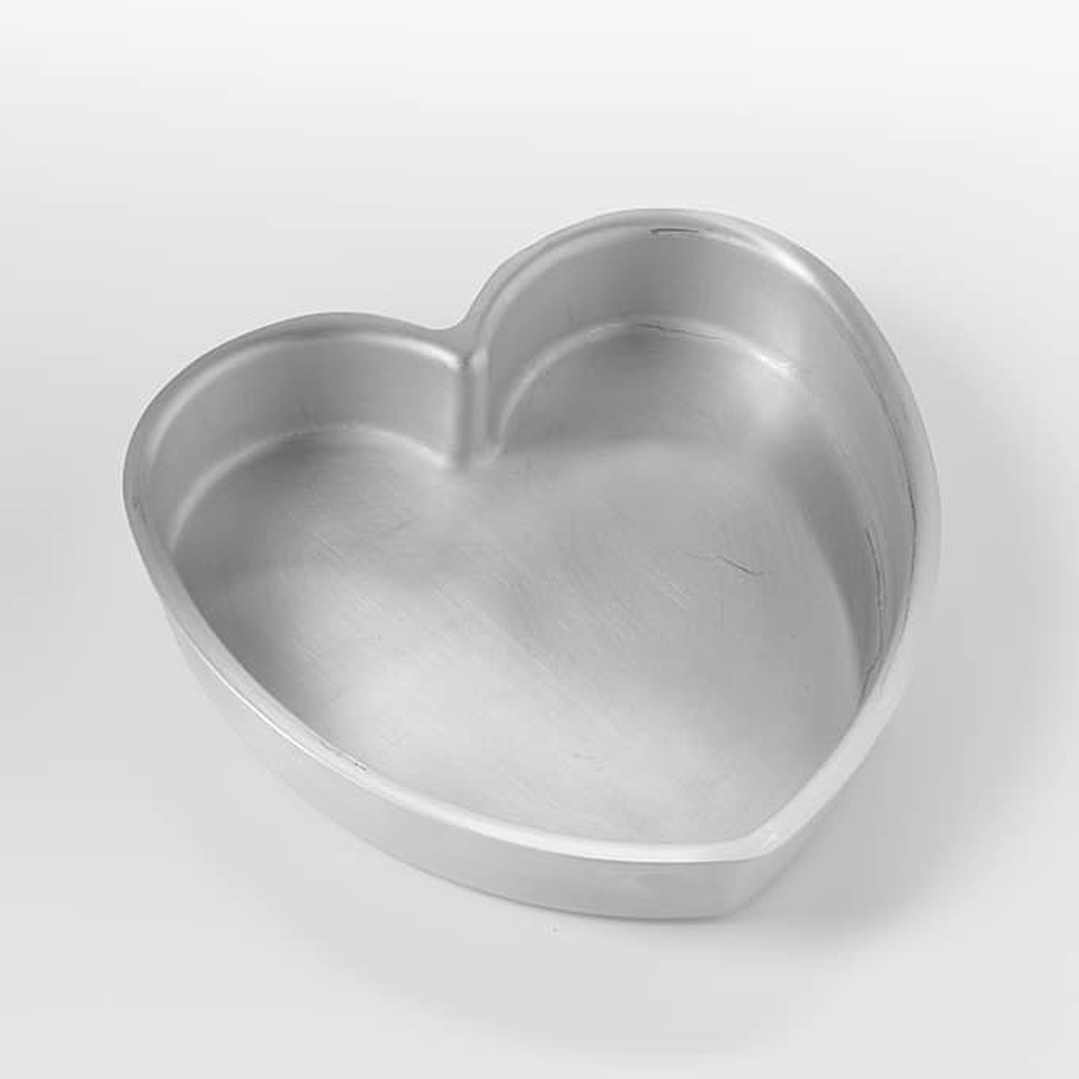 American Metalcraft HPP7 7-inch heart-shaped aluminum pan, silver finish, angled view showing 1.5-inch deep interior