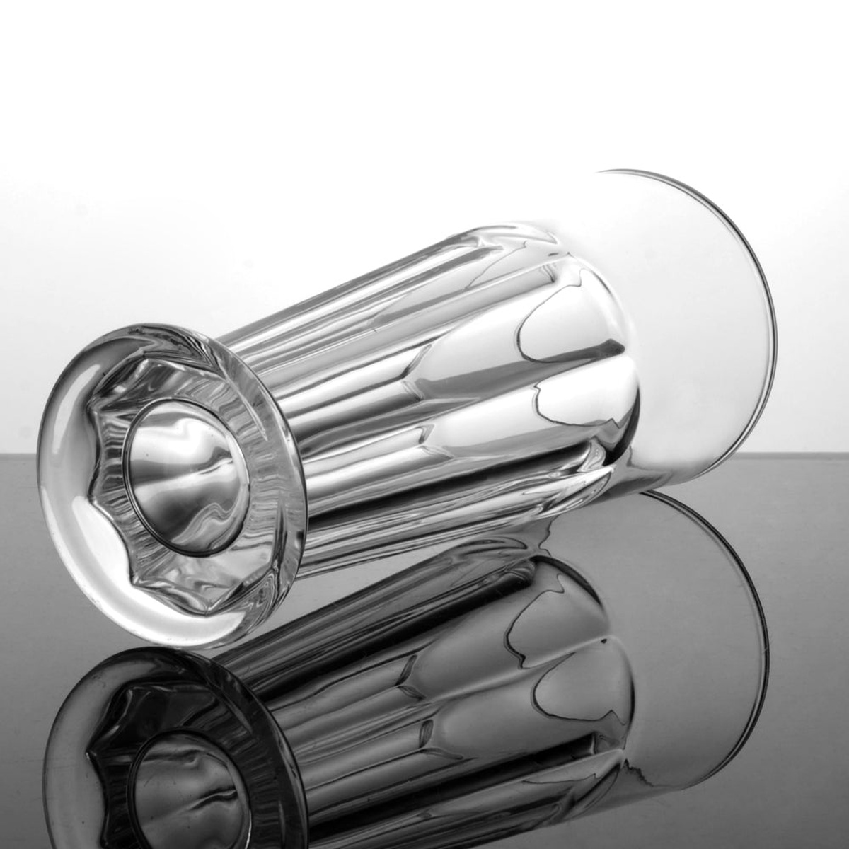 IC-17 Enhanced pilsner glass lying on its side, showcasing ribbed body and footed base detail
