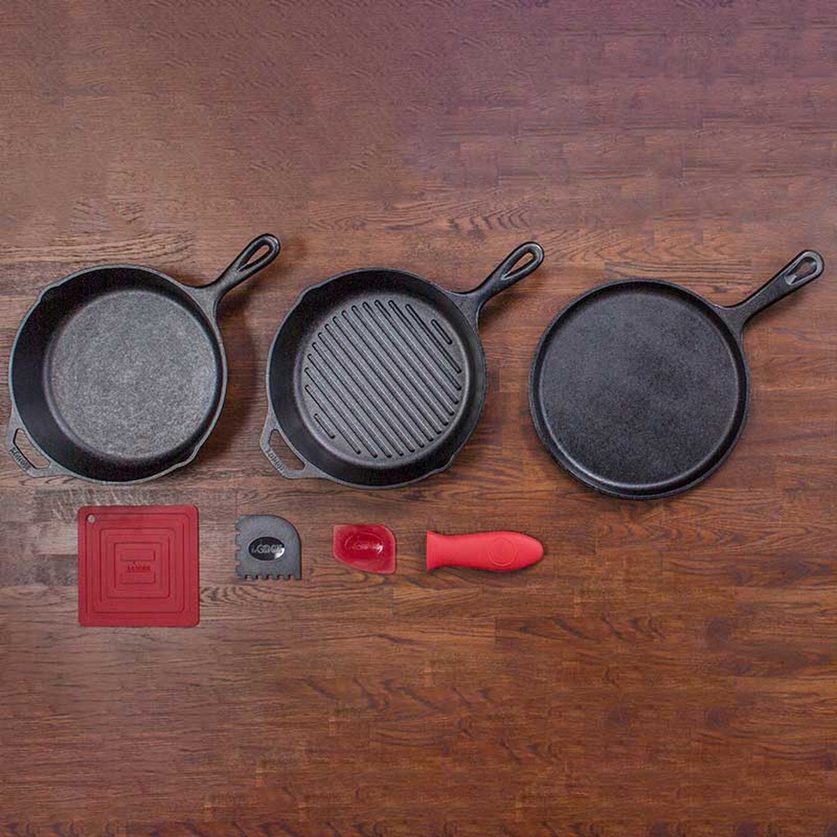 Top down view of the Lodge Essential Pan Set on a wooden surface