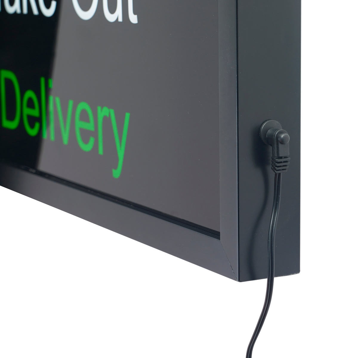 Close-up of the bottom corner of the Winco LED-20 sign showing the power cord connection port and cable