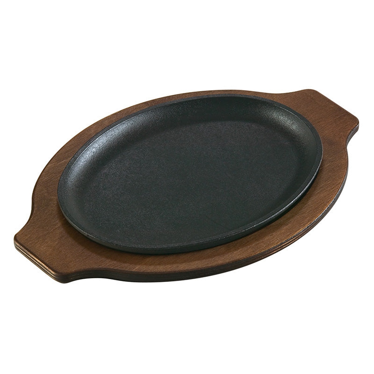Oval cast iron serving griddle resting on a dark wood underliner