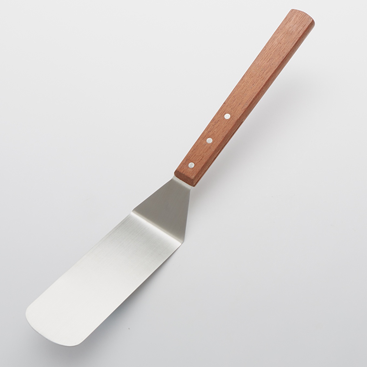 American Metalcraft LT20 stainless steel turner with solid blade and riveted wood handle against light background