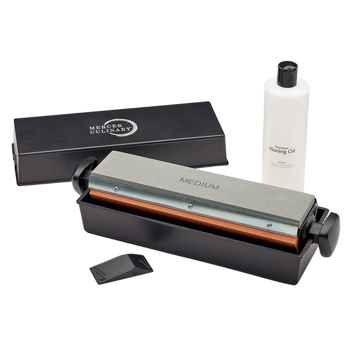 Mercer Culinary M15930 3-Way Sharpening System displayed with medium stone loaded in black ABS case, angle guide, and premium honing oil bottle