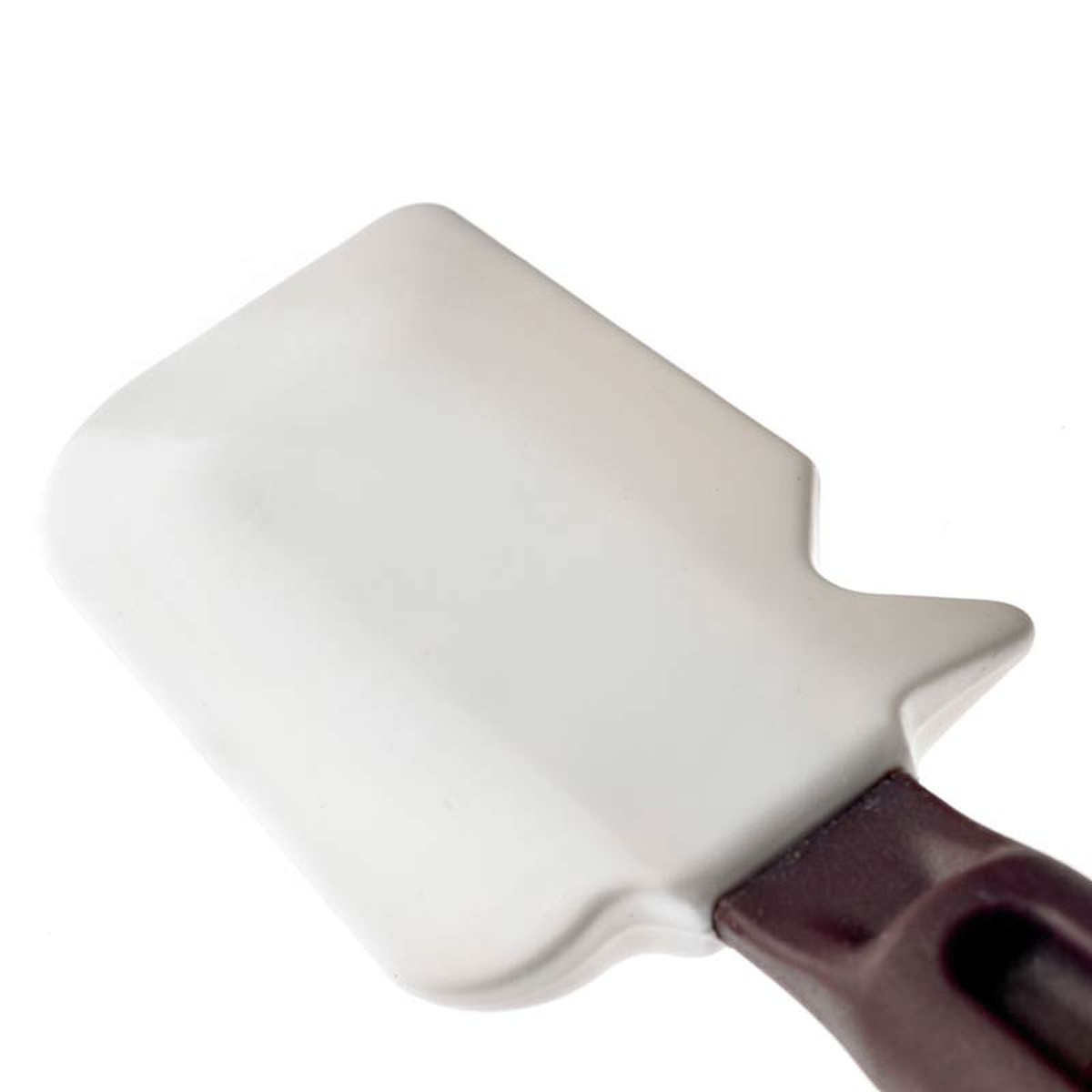 Close-up front view of the white flexible silicone spatula blade with notched corners and burgundy handle