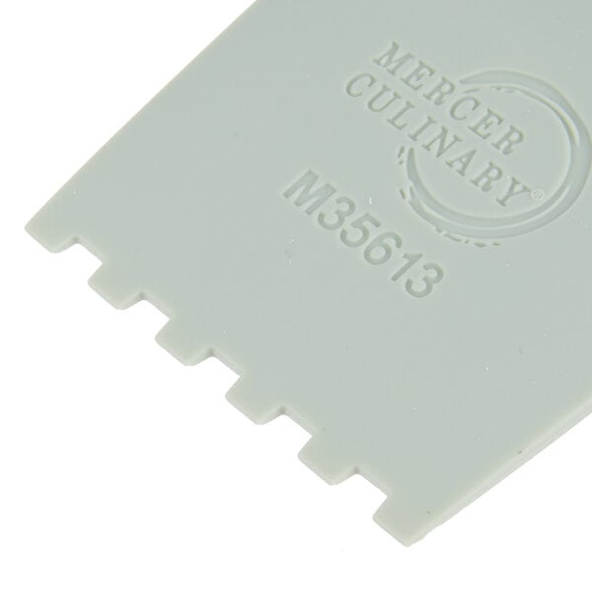 Close-up of the Mercer Culinary M35613 square notch edge showing five evenly spaced gaps in gray silicone