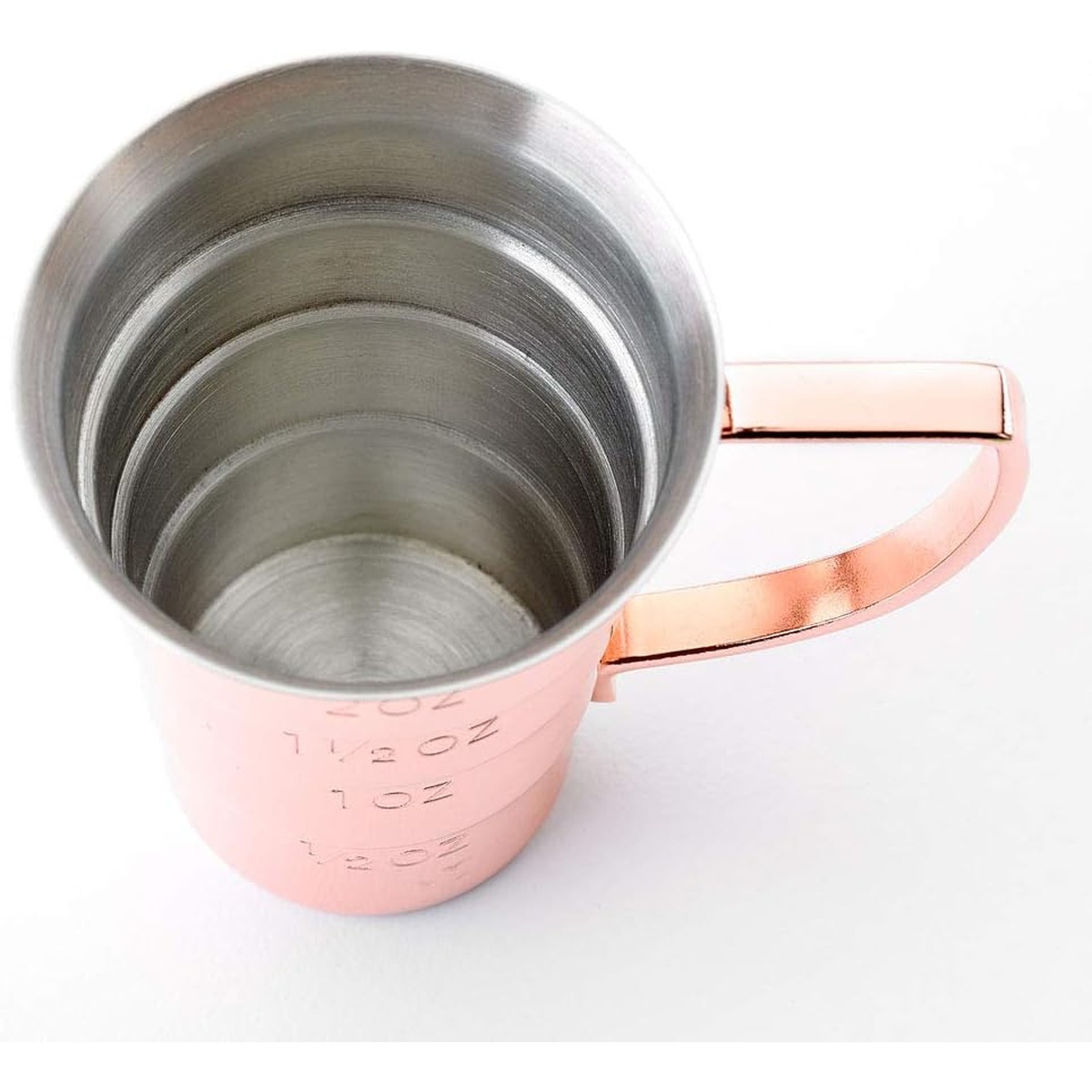 Top-down interior view of copper jigger revealing brushed stainless steel inner surface