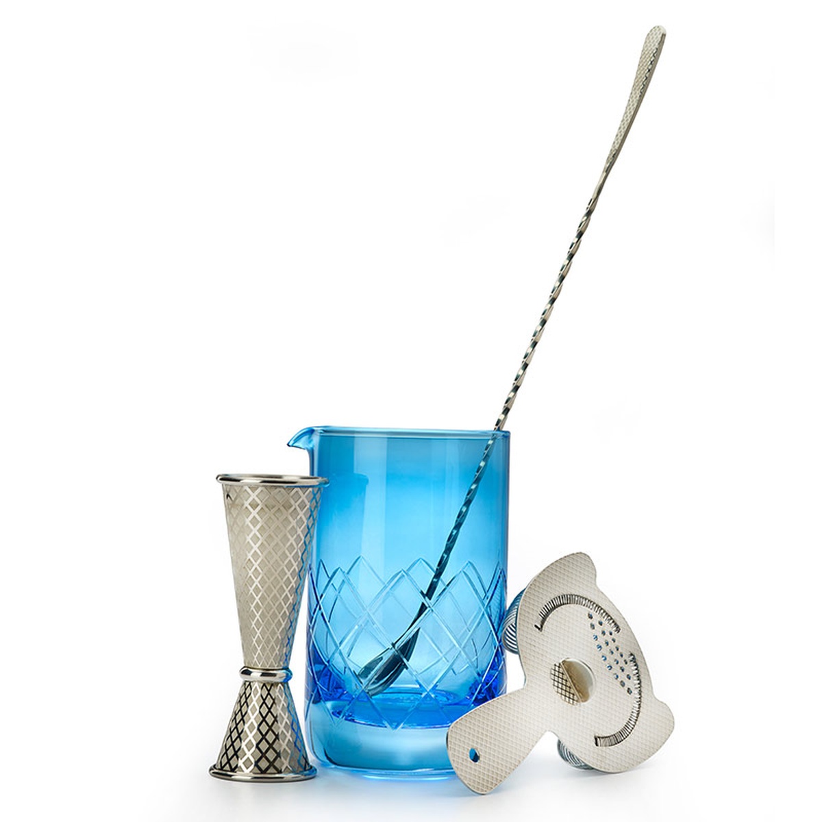 Barfly blue mixing glass displayed alongside a bar spoon, jigger, and julep strainer on a white background