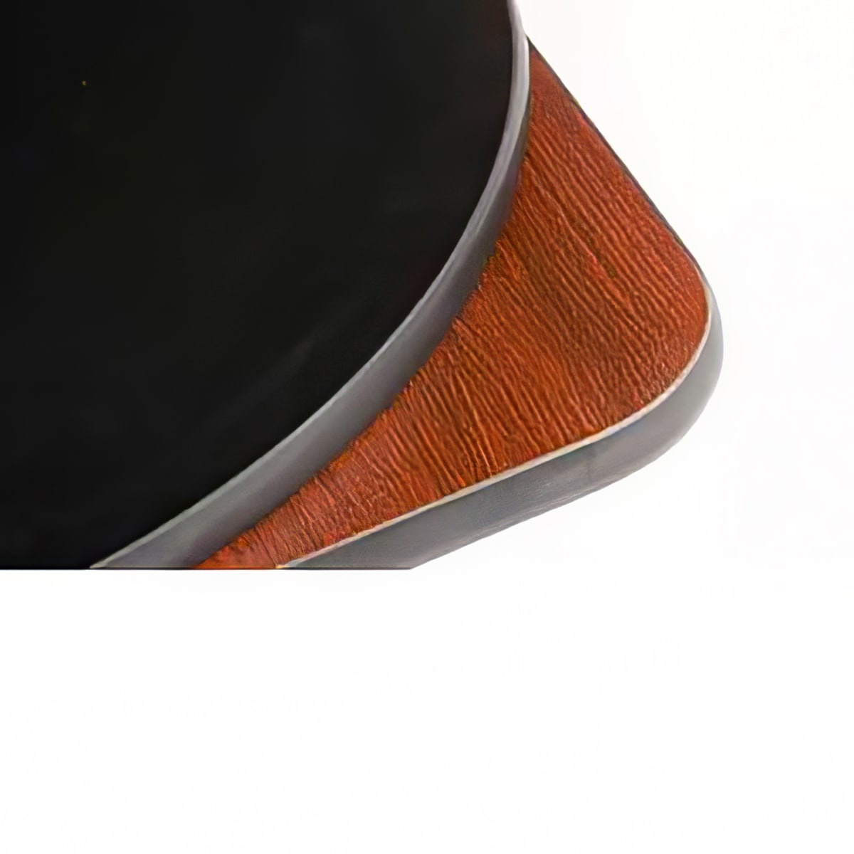 Corner detail of 36-inch square reversible melamine table top showing black finish on top side, mahogany wood-grain finish on underside, and black rubber T-mold edge