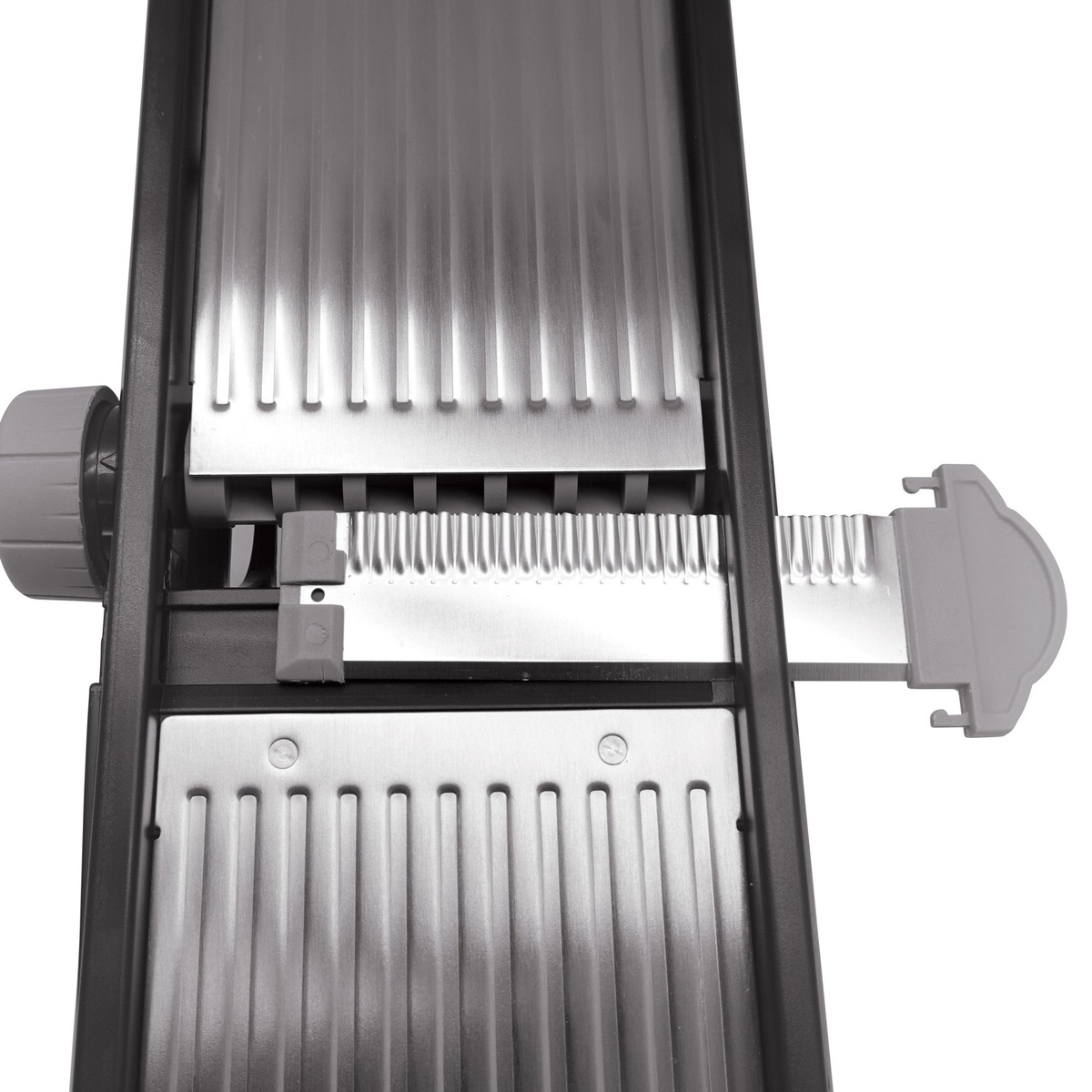 Close-up of the Winco MDL-4P mandoline blade assembly showing the stainless steel slicing deck and interchangeable blade mechanism