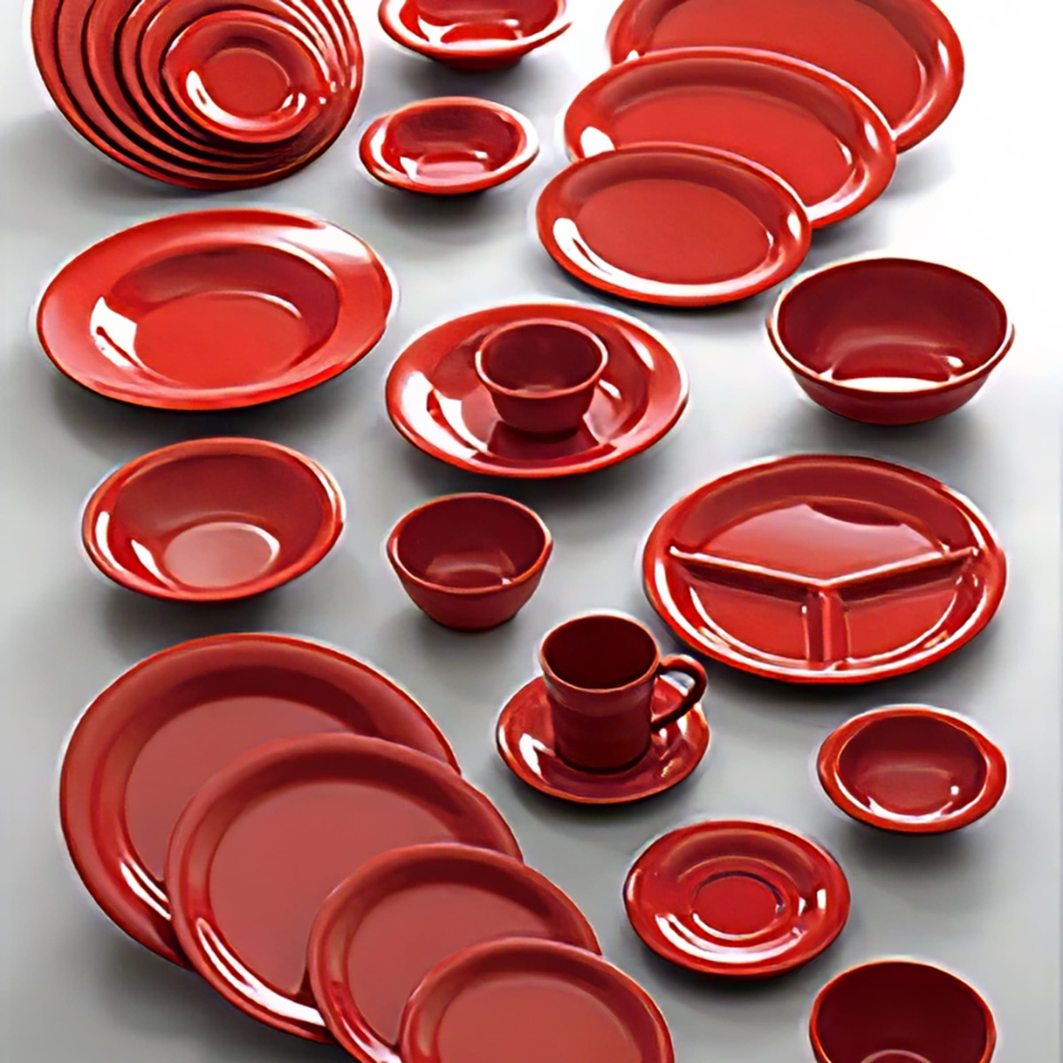 Thunder Group pure red melamine dinnerware collection including plates, bowls, ramekins, and cups displayed on a gray surface