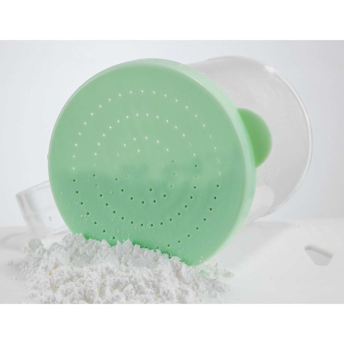 Fine green snap-on lid showing tiny 0.95mm perforations with white powder