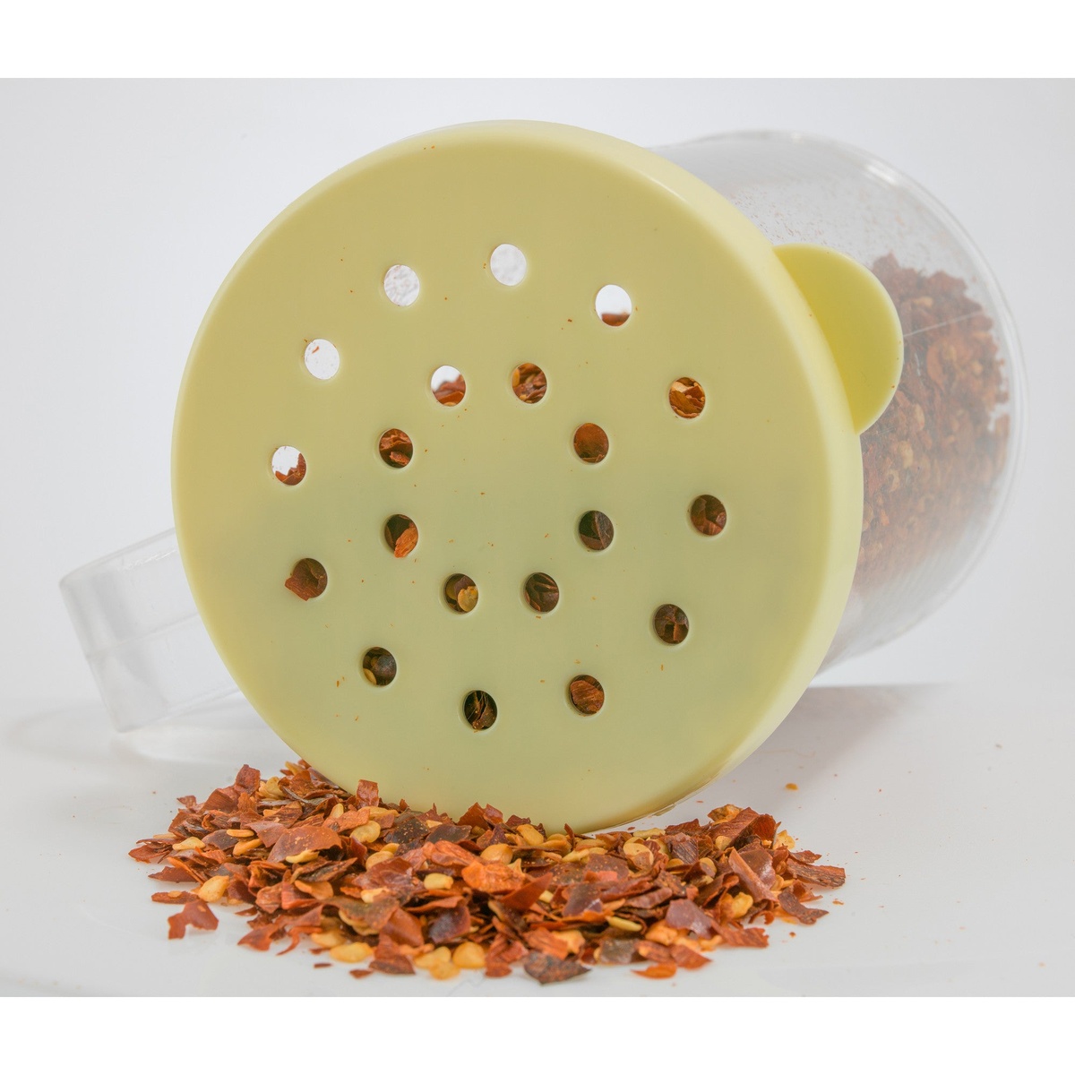 Extra-coarse yellow snap-on lid showing large 4.8mm perforations with chili flakes