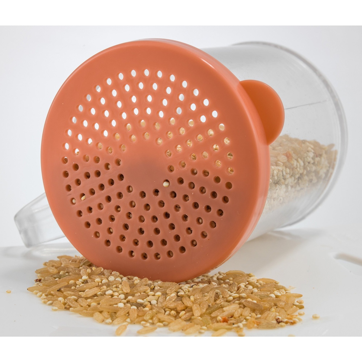 Medium brown snap-on lid with mixed-size perforations and grains spilling out