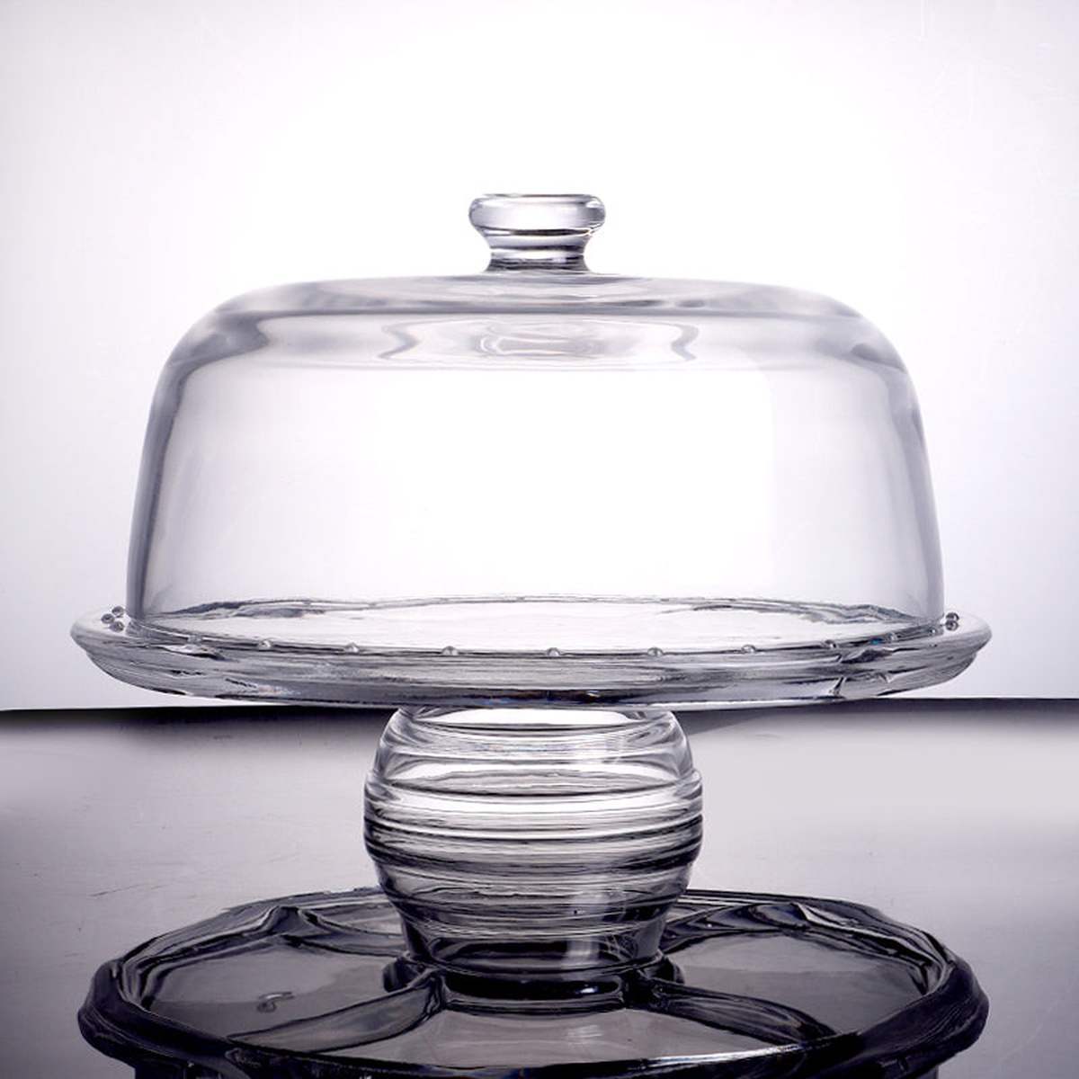 Enhanced Glass Cake Stand with dome cover assembled on pedestal, with divided base plate below