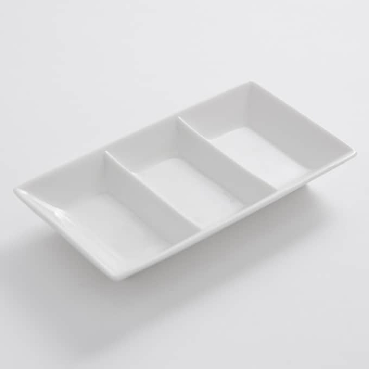 American Metalcraft PORSD3R white porcelain 3-compartment rectangular sauce dish viewed at an angle
