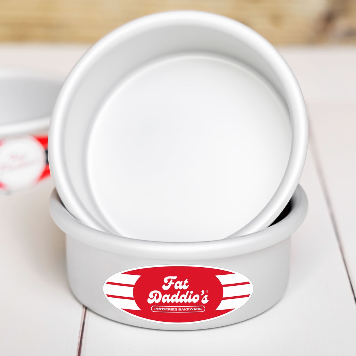 Two Fat Daddio's round cake pans stacked, showing interior and brand label