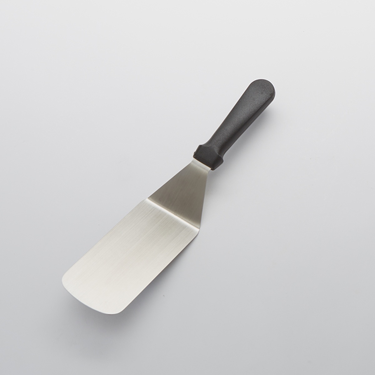 American Metalcraft PS12 stainless steel offset turner with black plastic handle on neutral background