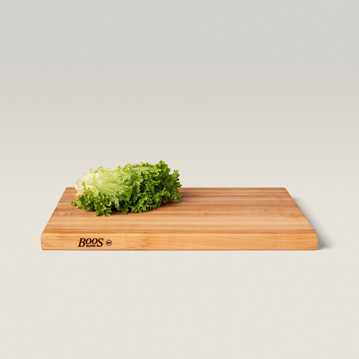 John Boos R02 maple cutting board with fresh lettuce displayed on the surface, Boos Block NSF logo visible