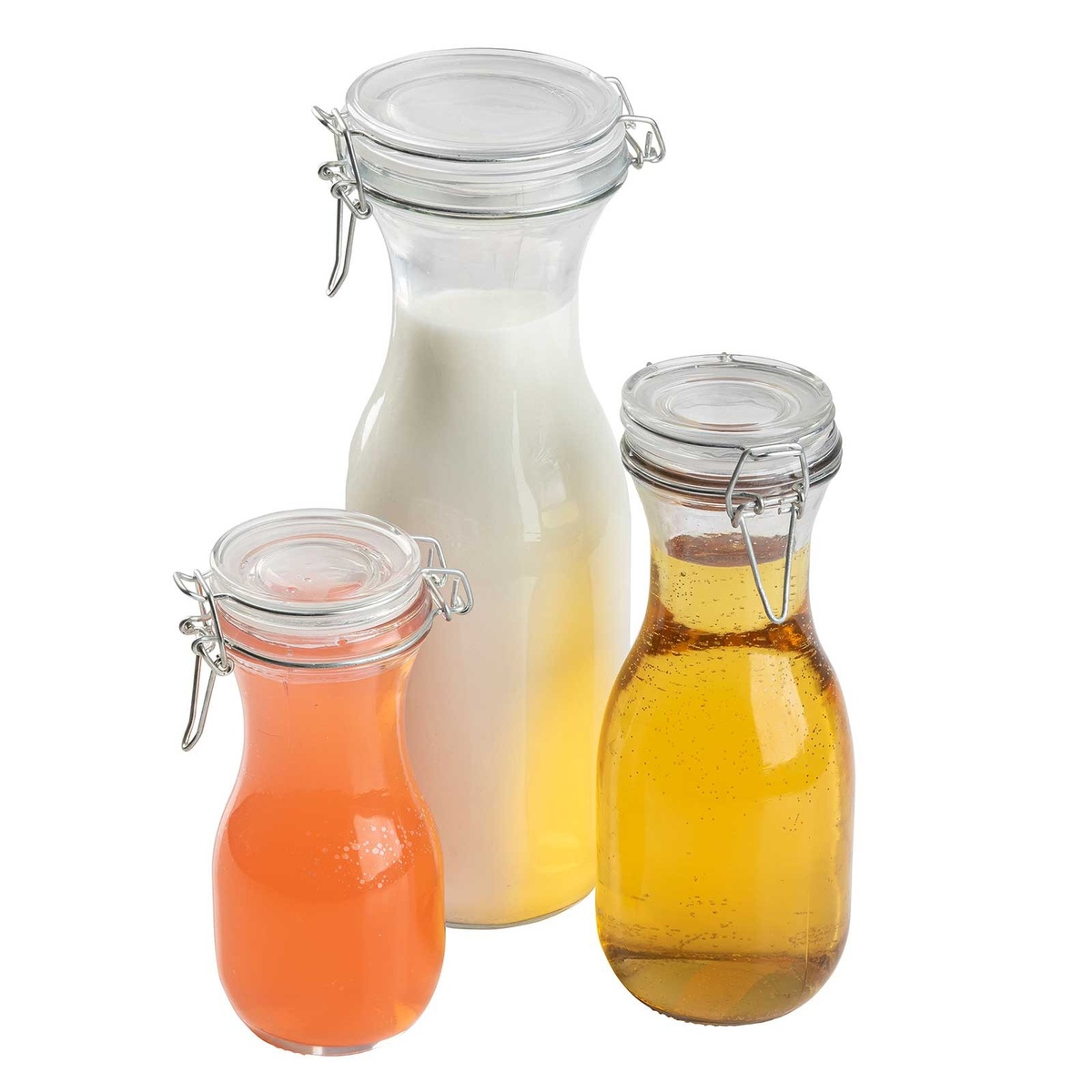 Three TableCraft resealable glass carafes of different sizes filled with milk, orange juice, and amber beverage on white background