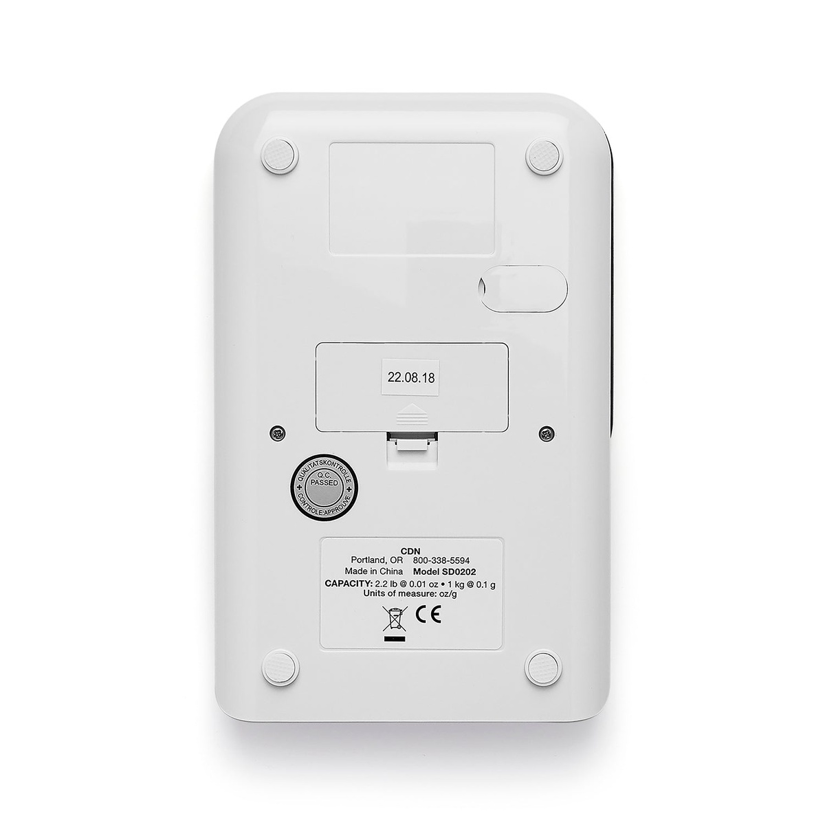 CDN SD0202-GY precision scale bottom view showing battery compartment cover, model label with capacity specifications, and rubber non-slip feet