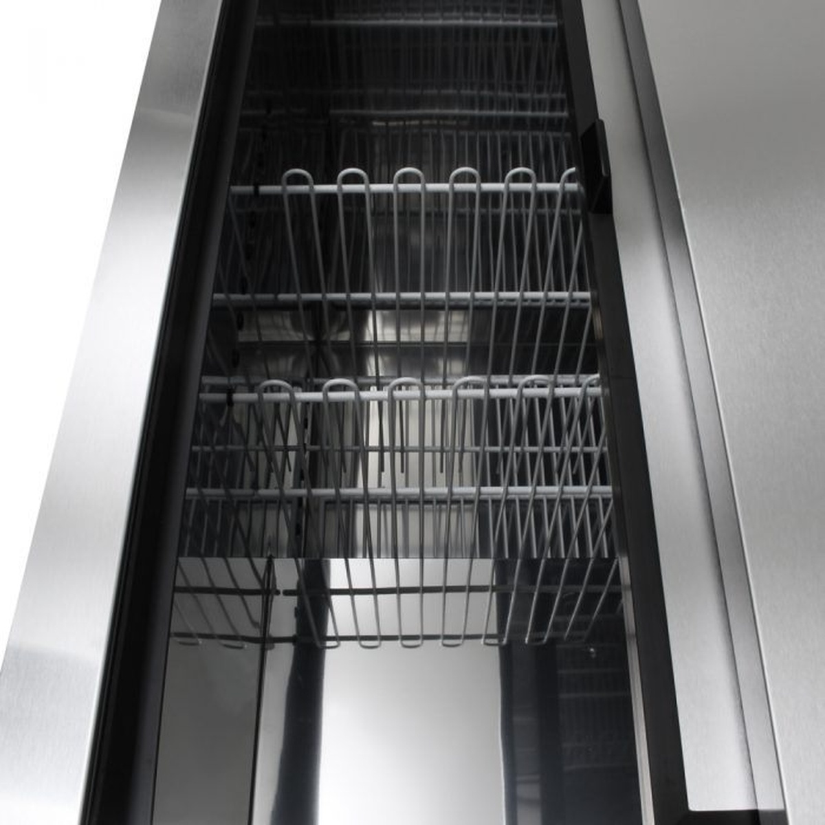 Interior view of Turbo Air TBC-50SB-N6 bottle cooler showing stainless steel walls and wire divider racks for bottle organization
