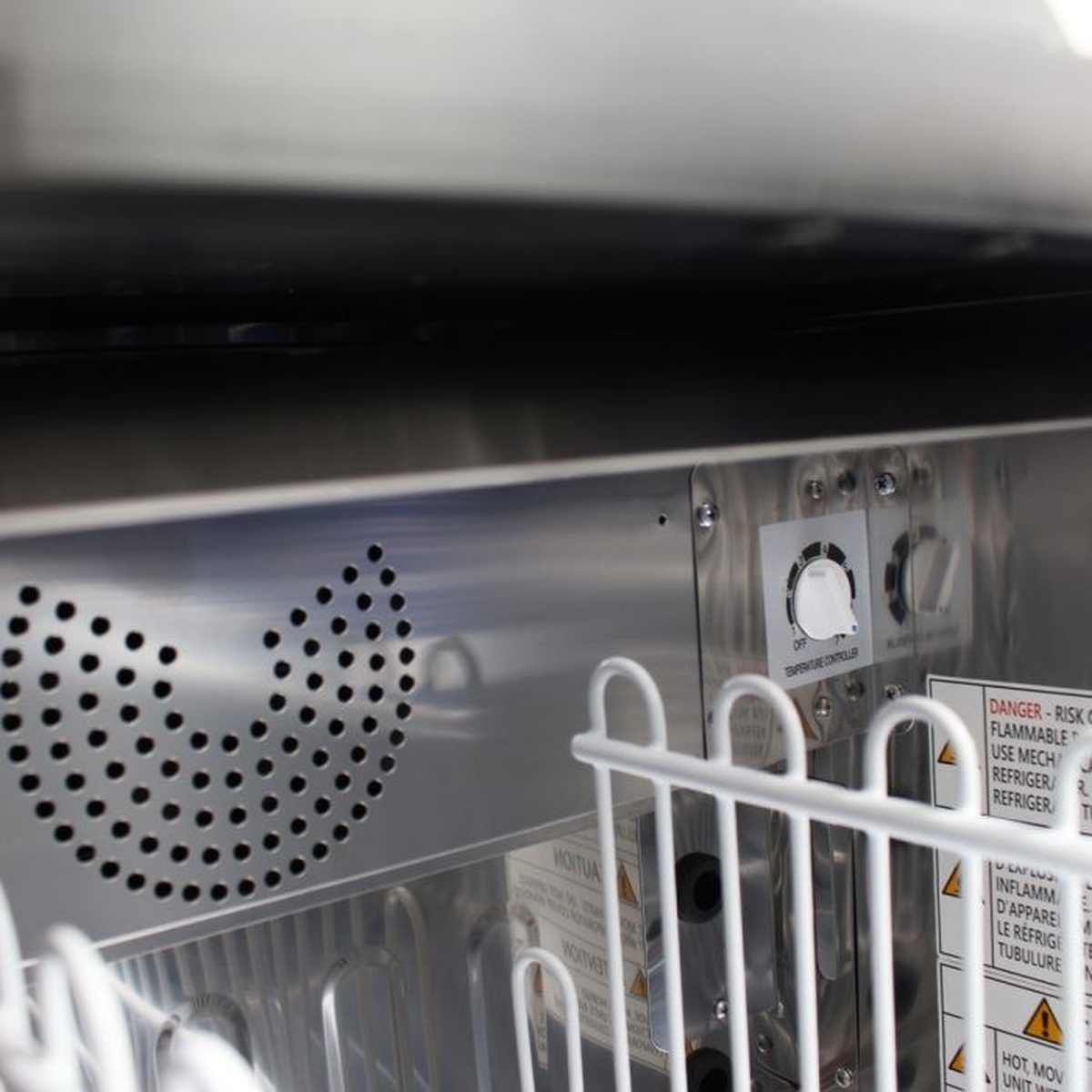 Interior close-up showing bottle cooler control area and fan cover