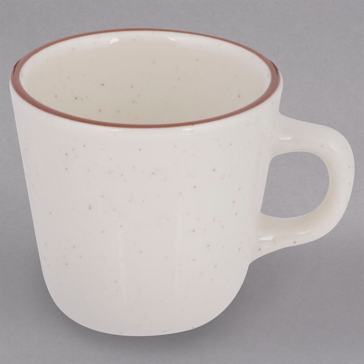 Tuxton TBS-001 Bahamas 7 oz. tall china cup with brown speckle pattern and brown rim band on gray background