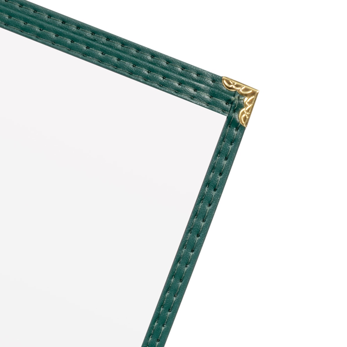 Close-up detail of double-stitched green leatherette edge and decorative gold metal corner on menu cover
