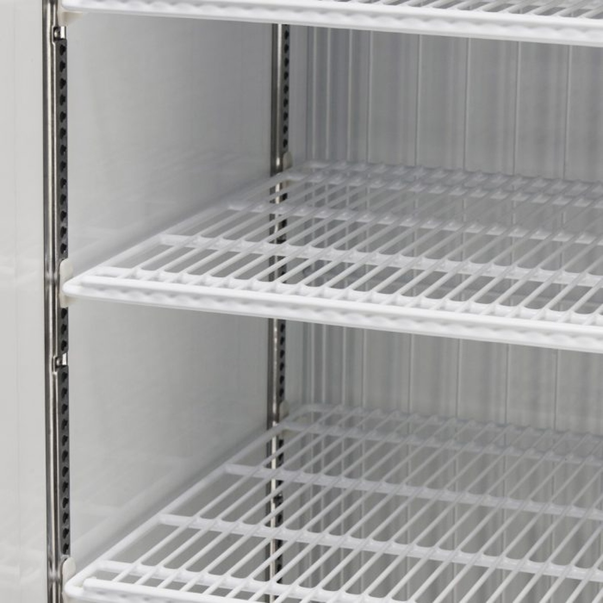 Close-up of adjustable PE-coated wire shelves inside freezer