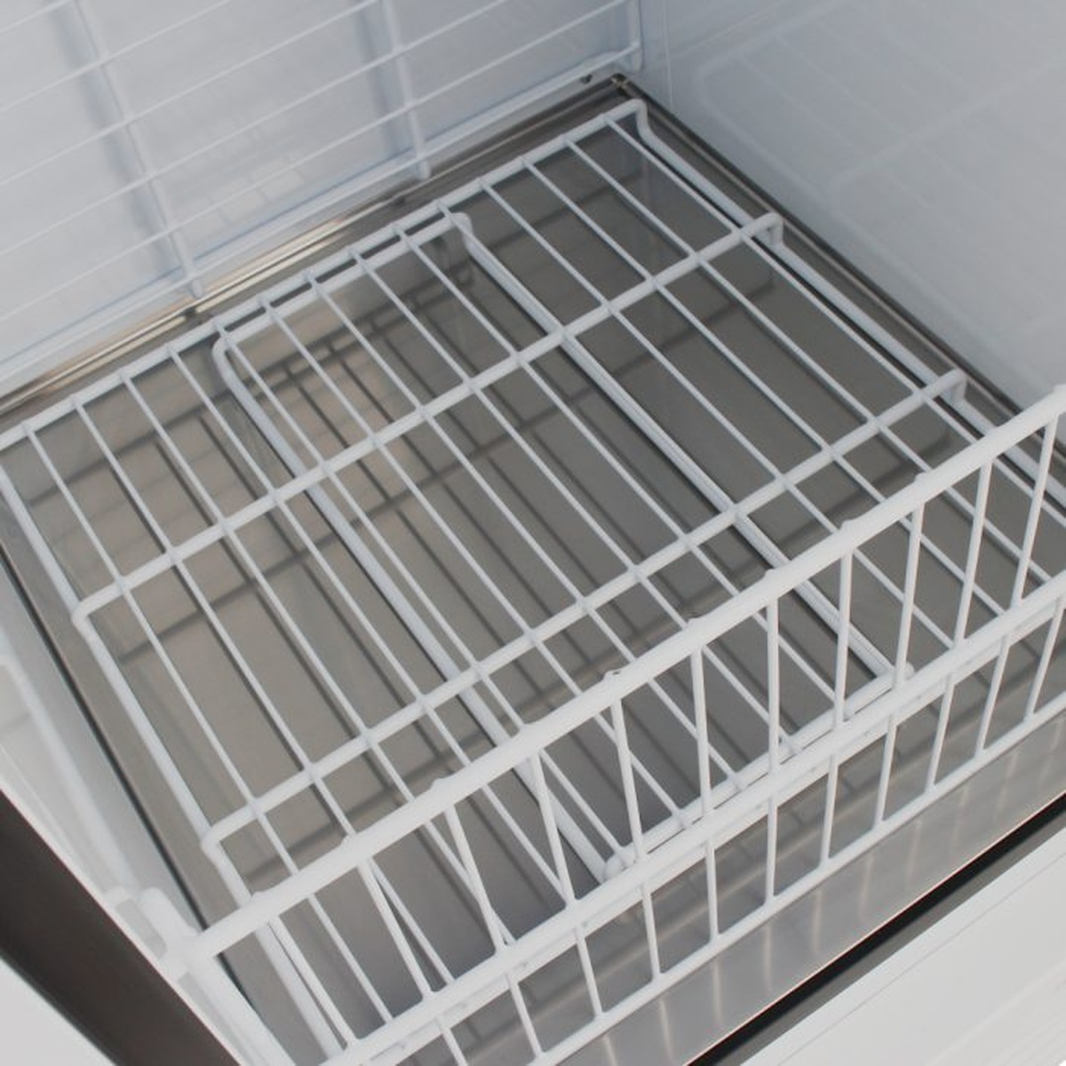 Interior wire basket and floor of Turbo Air TGIM-23W-N ice merchandiser freezer