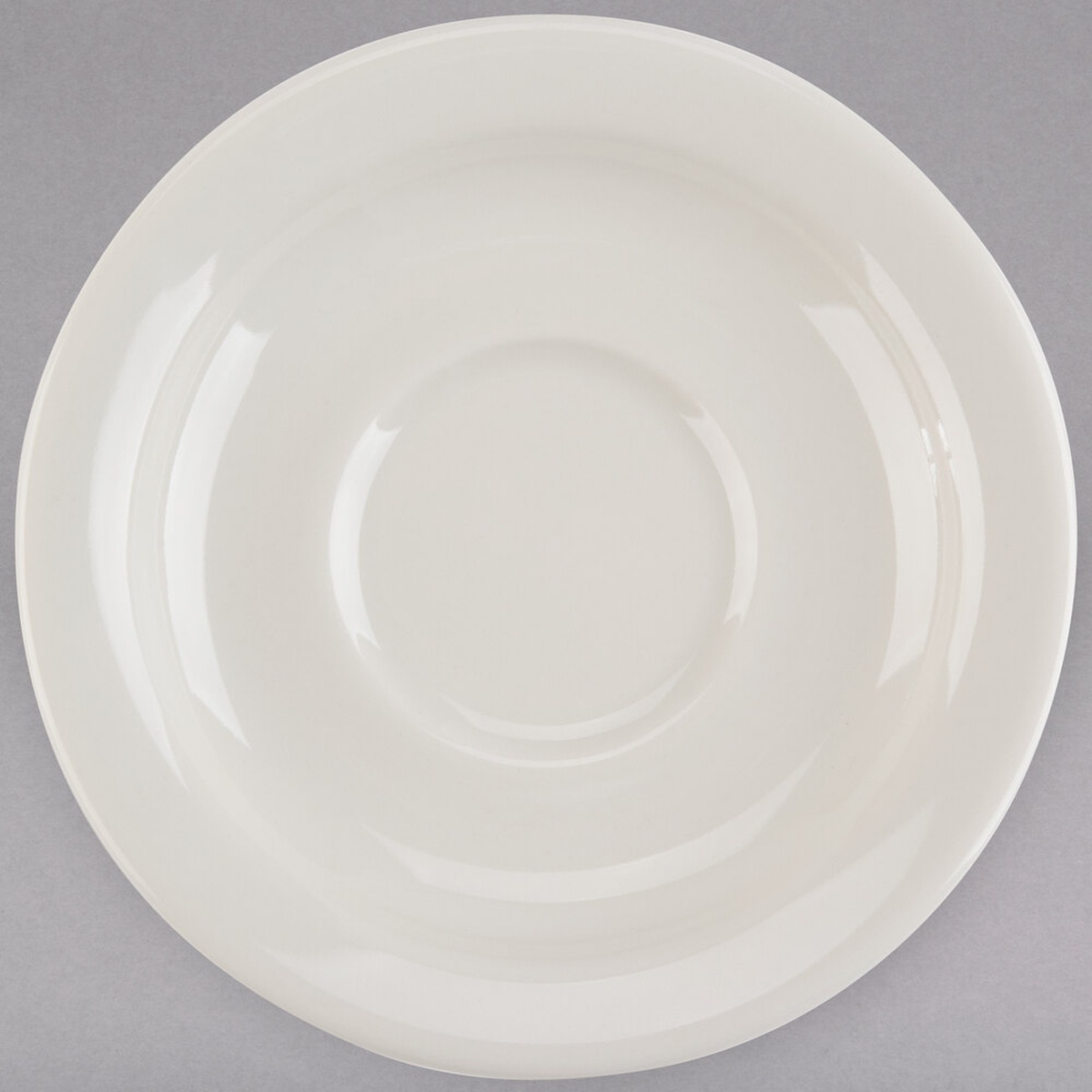 Tuxton TNR-002 5-1/2 inch eggshell narrow rim china saucer, top-down view showing concentric ring detail and polished finish