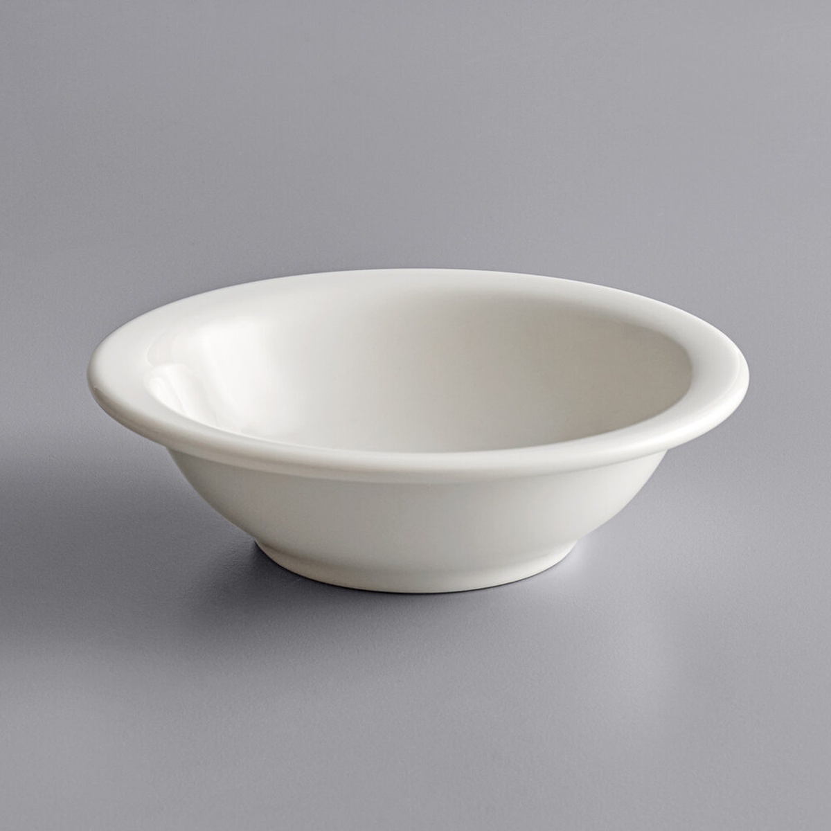 Tuxton TNR-057 eggshell narrow rim china grapefruit bowl, angled view showing polished finish and contoured profile