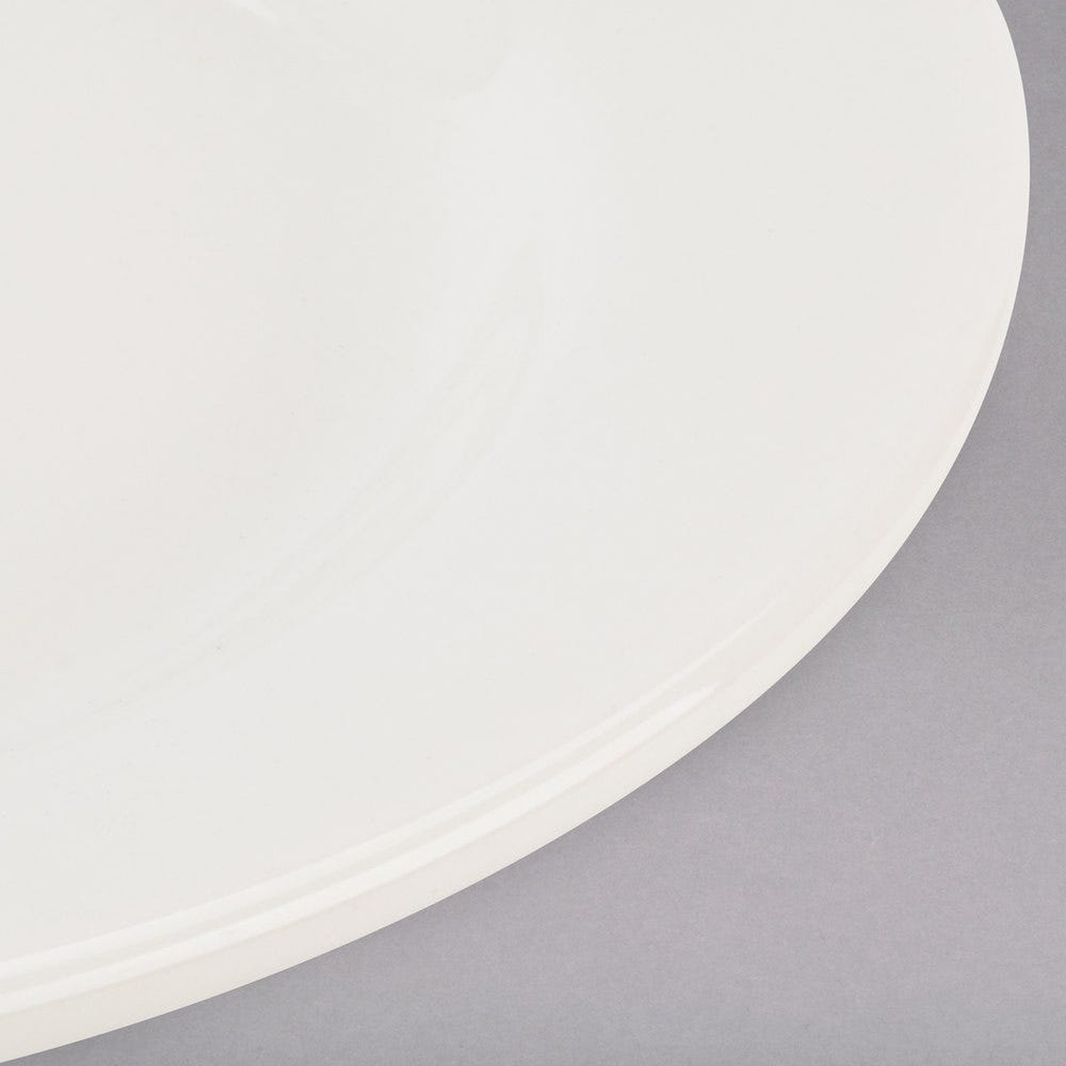 Close-up detail of the Tuxton TRE-022 plate rim showing smooth rolled edge and eggshell glaze