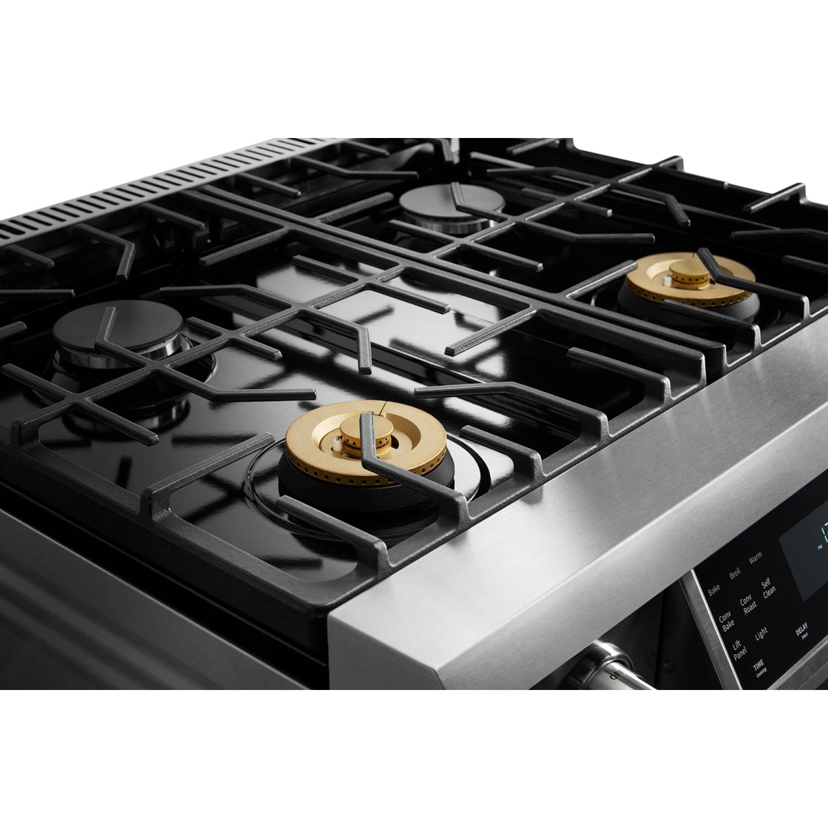 Close-up of cooktop showing continuous cast-iron grates and gas burners