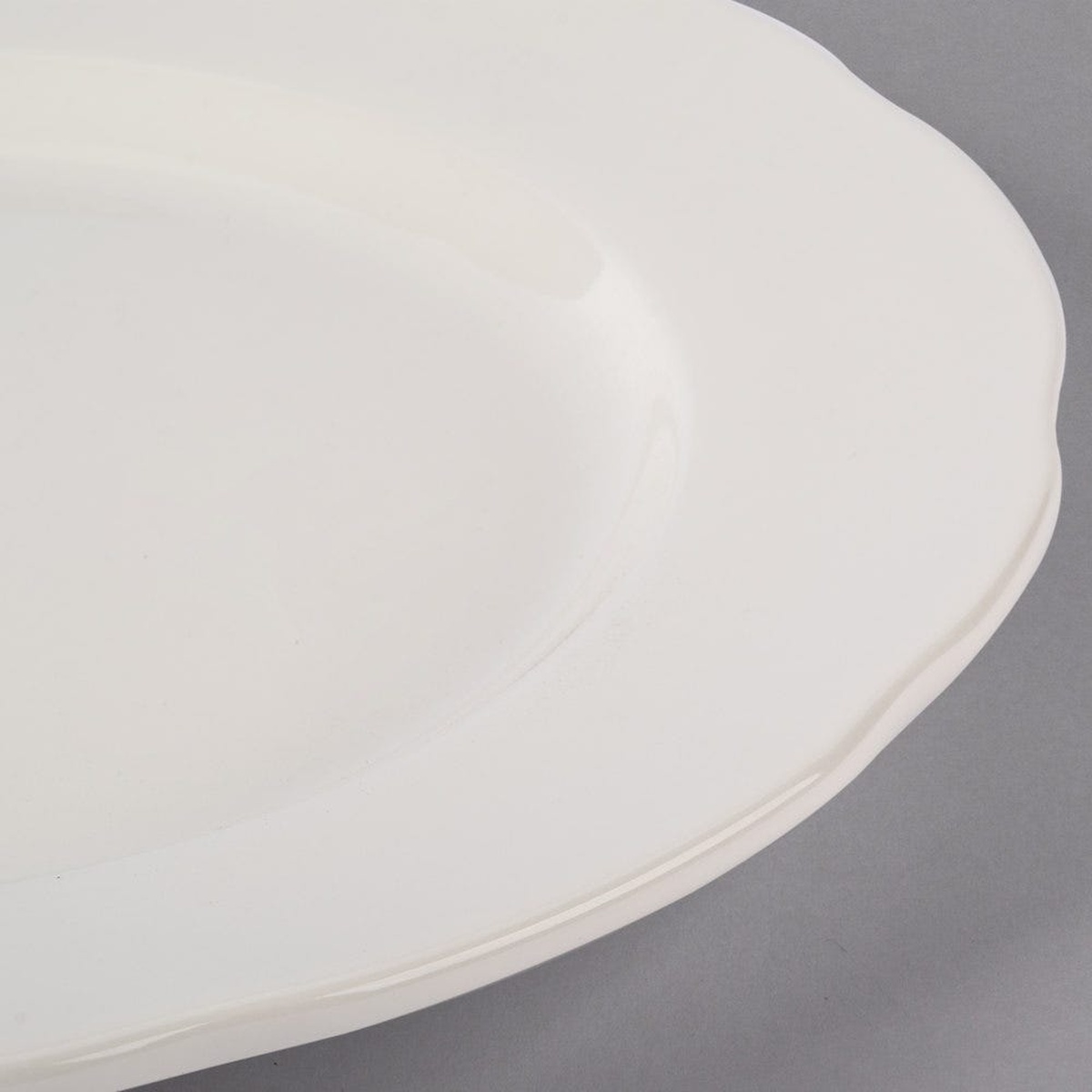 Close-up detail of the scalloped edge on the Tuxton TSC-016 eggshell china plate