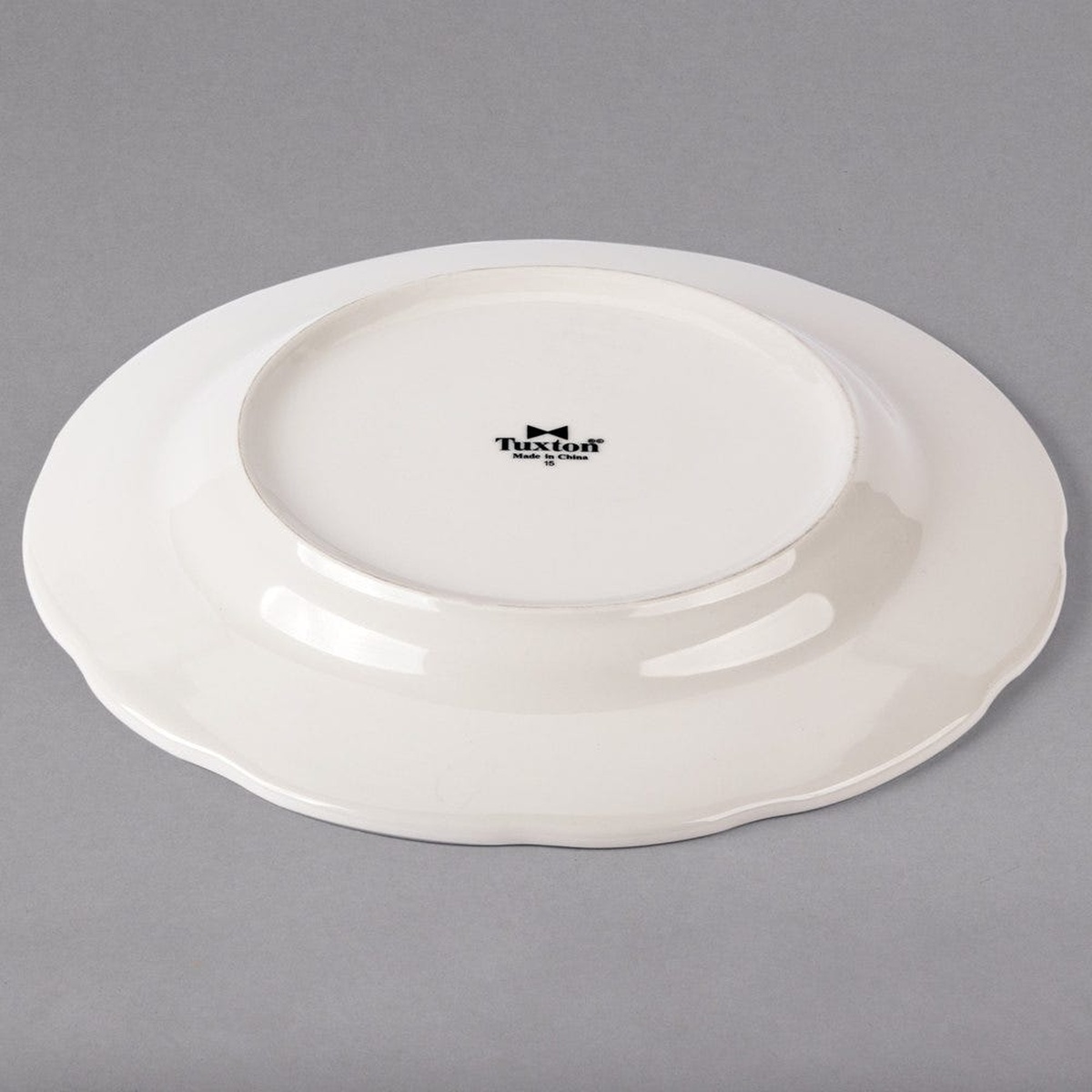 Tuxton TSC-016 china plate underside showing brand stamp and footed base profile